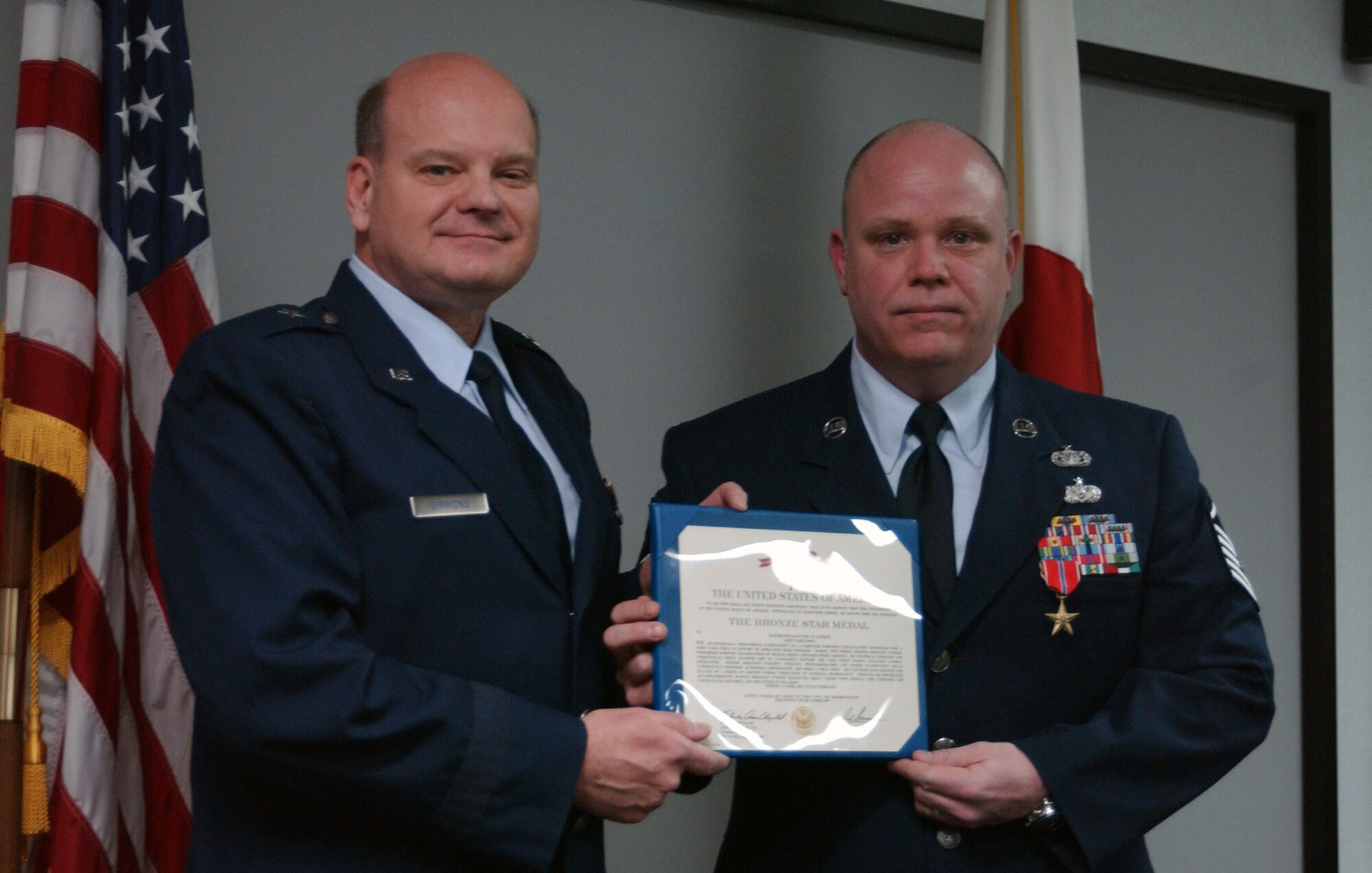 YOKOTA AIR BASE, Japan-- Master Sgt. Eric O'Keefe, a computer crime investigator,  recieves the Bronze Star from Brig. Gen. Dana Simmons, Office of Special Investigations commanding officer, here Feb. 26. Sergeant O'Keefe was earned the award for his work while deployed to Southwest Asia from April to October 2007. (U.S. Air Force photo by Senior Airman Brian Kimball.)                             