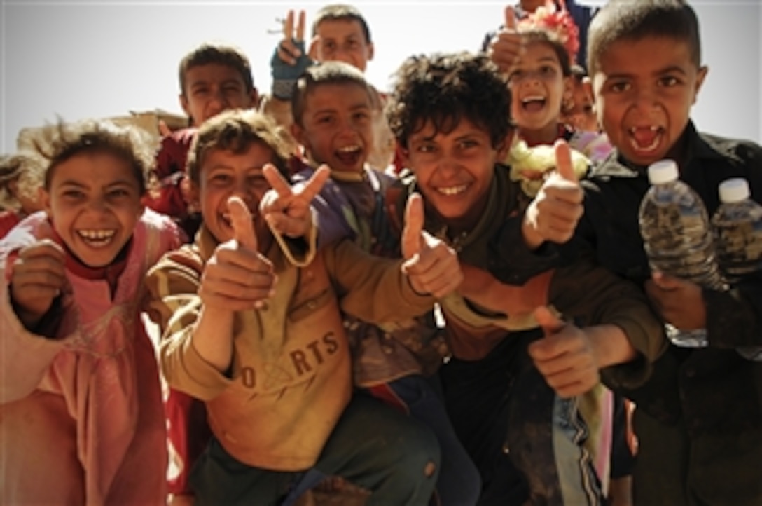 Iraqi children show their enthusiasm as U.S. soldiers conduct a humanitarian aid mission in Al Makum, Iraq, March 4, 2008. The Soldiers are from 3rd Battalion, 6th Field Artillery Regiment, 1st Brigade Comabat Team, 10th Mountain Division. 