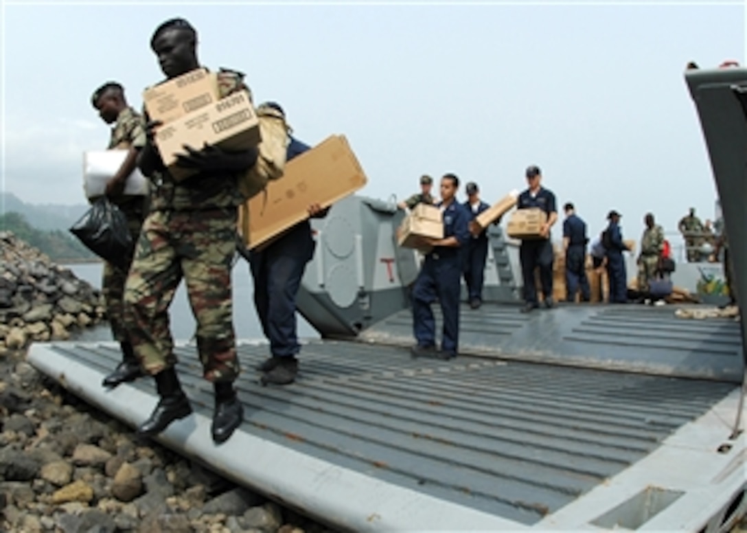 U.S. Navy sailors and Cameroon Naval Forces sailors unload medical supplies donated by Project Handclasp from amphibious dock landing ship USS Fort McHenry (LSD 43) to a landing craft for transport to Limbe Naval Base, Cameroon, on Feb. 28, 2008.  The sailors are supporting Africa Partnership Station, a multinational effort to bring the latest training and techniques to maritime professionals in nine west and central African countries.  