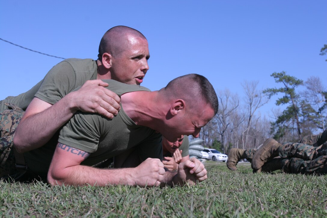 Lance Cpl. Kyle Gottshall, a machine gunner with Weapons platoon, Company F, 2nd Battalion, 6th Marine Regiment, 2nd Marine Division, buddy-team crawls from one station to another while conducting Marine Corps Martial Arts Program training here March 6. The drills tested the Marines on their Marine Corps Martial Arts Program skills while conducting combat conditioning.