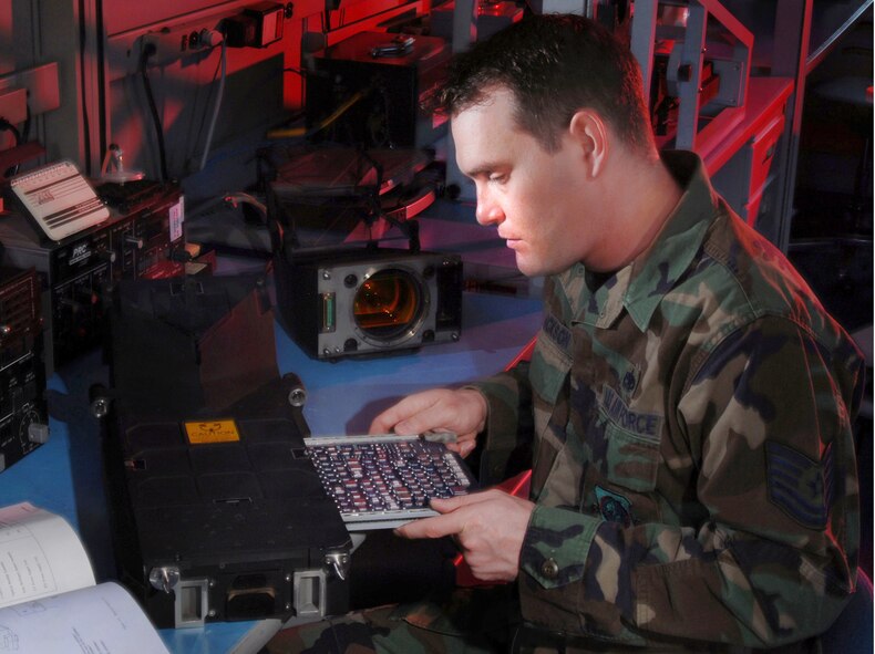 Technical Sgt. James Erickson, an avionics integrated technician from the 452nd Maintenance Squadron, March Air Reserve Base, Calif., removes a circuit card assembly of a C-17 Globemaster III cargo aircraft Head-Up Display (HUD) display. Avionics technicians install, maintain and repair electronic and electrical systems on all types of aircraft and they also maintain a high degree of readiness here to deploy worldwide to support wartime and contingency operations, and operations other than war in support of national interests and objectives. (U.S. Air Force photo by Val Gempis)