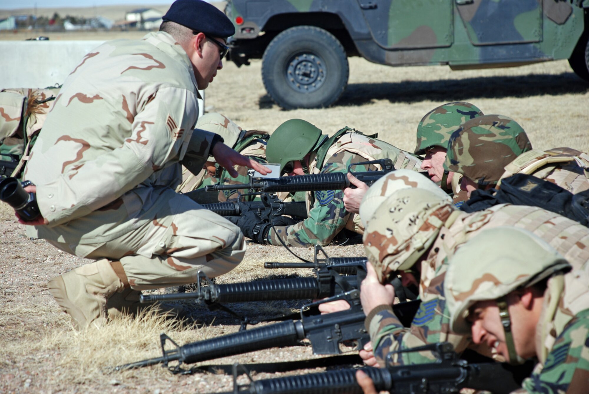 Senior Airmen Luis Lopez, 90th Missile Security Force Squadron, instructs students Feb. 29 on team movements when engaging a hostile target at the base training grounds. The 14 Airmen were separated into three fire teams and moved strategically throughout the grounds (U.S. Air Force photo by Airman 1st Class Daryl Knee).
