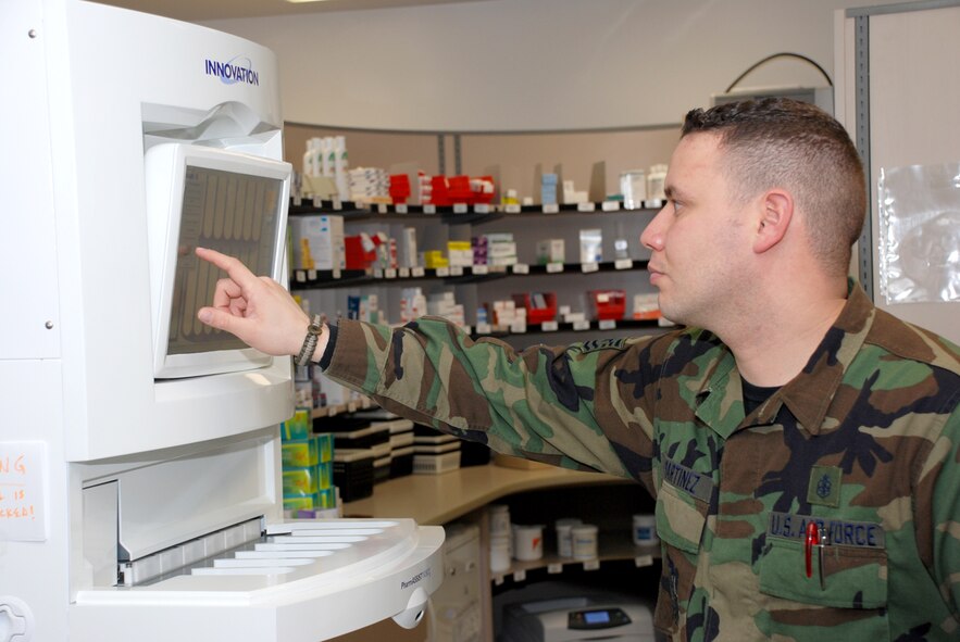 Tech. Sgt. Ernest Martinez, 90th Medical Support Squadron, operates the electronic interface of the Robotic Counting and Dispensing System here Feb. 27. (U.S. Air Force photos/Airman 1st Class Daryl Knee).