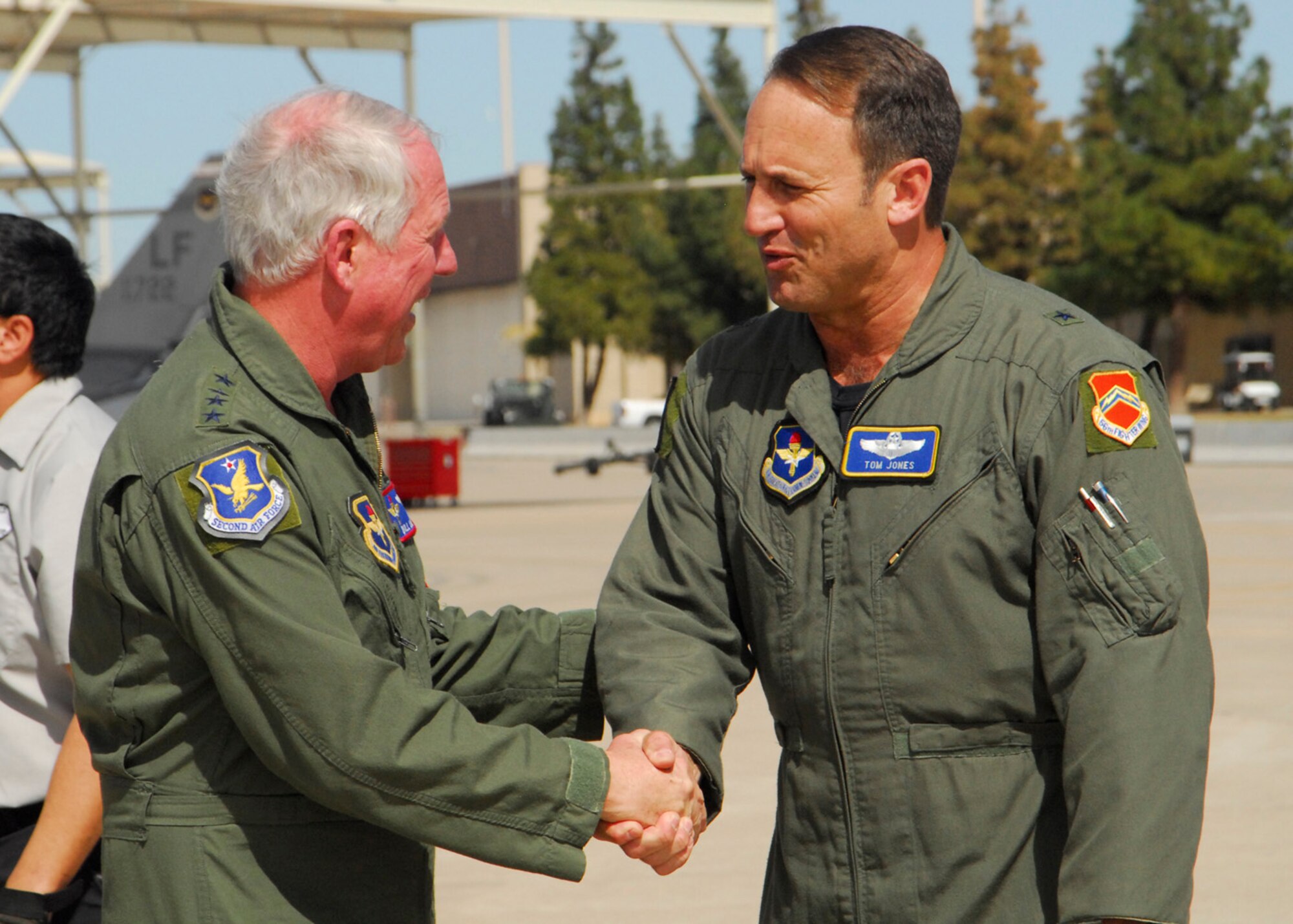Brig. Gen Tom Jones (right) welcomes Gen. William R. Looney III to Luke Air Force Base, Ariz., Feb. 25. General Looney, the commander of Air Education and Training Command, and other leaders were at Luke AFB for the AETC commanders' and command chiefs' conference. General Jones is the 56th Fighter Wing commander. (U.S. Air Force photo/Master Sgt. William Gomez) 
