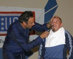 Brad Garrett, star of the television sitcom "Til Death," gives Gateway Club employee Steve Tovar a shave during a USO performance on Lackland Feb. 26. Mr. Garrett performed stand-up acts along with comedian Michael Jr. to a packed audience at the Gateway Club. (USAF photo by Alan Boedeker)             