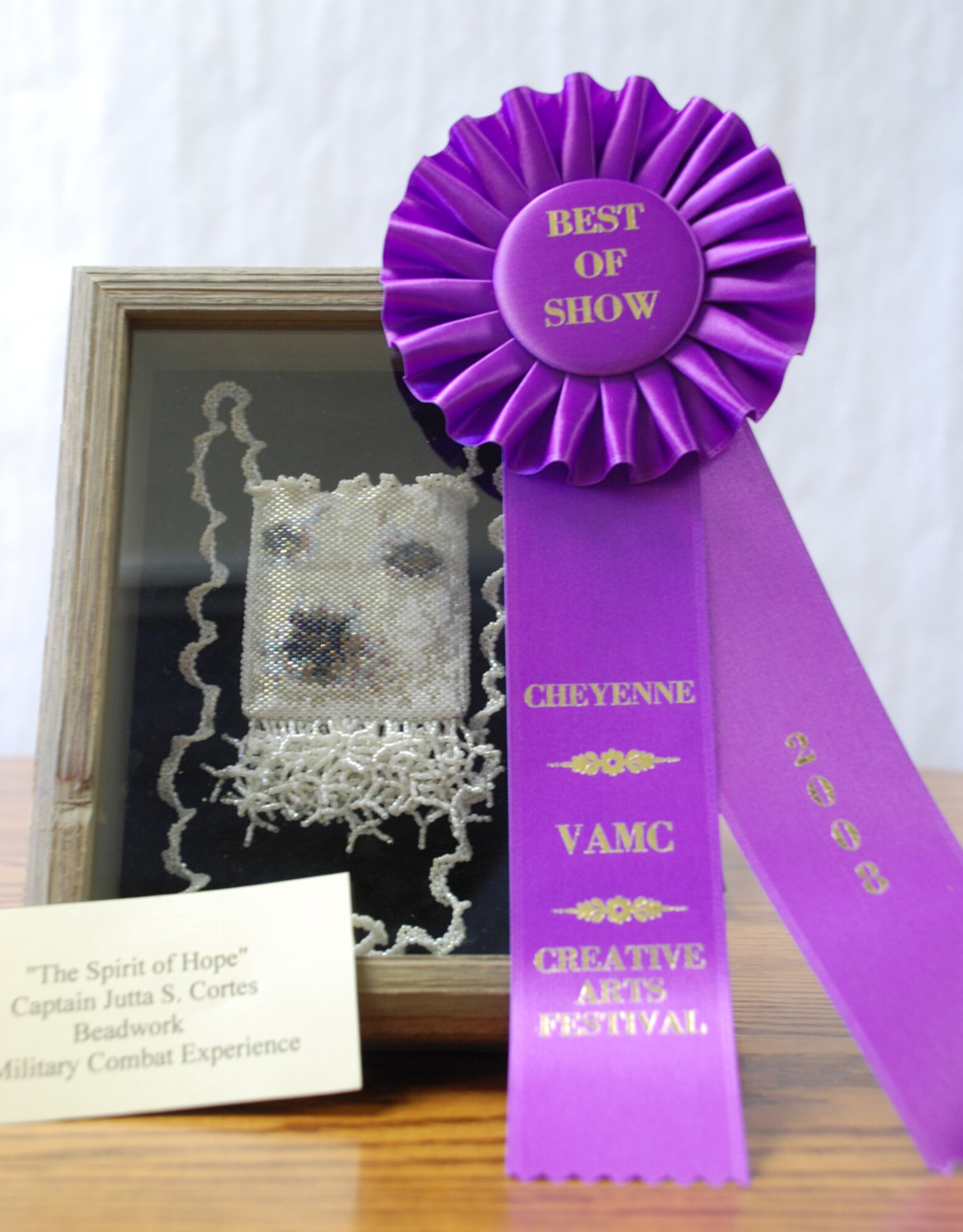 Capt. Jutta Cortes, 90th Space Wing plans and programs, won best of show in the beadwork category at the Veterans Administration Medical Center Creative Arts Festival Feb. 19. Captain Cortes created this Harp Seal Amulet Bag while deployed to Iraq. The seal represents the helplessness of good people oppressed by terrorism. The seal’s eyes represent glimmering hope for a brighter future free from fear and violence (U.S. Air Force photo/Airman 1st Class Alex Martinez).
