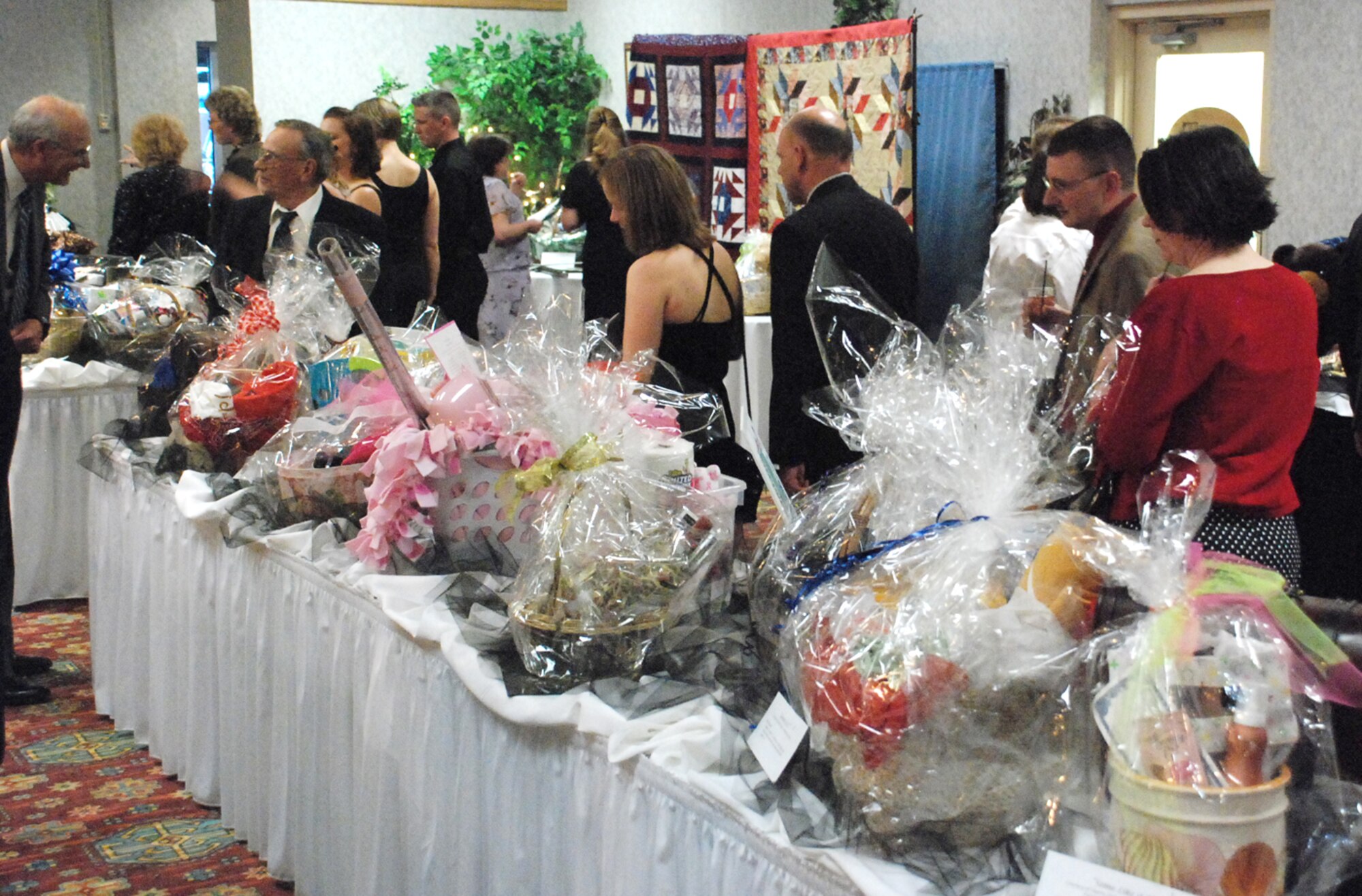 Guests look at the baskets being auctioned during the Warren Spouse’s Club fourth annual Dollars for Scholar basket auction in the Trail’s End Club March 1. This year the WSC had more than 60 baskets donated for the auction. The auction raised $17,319 for the scholarship fund to help military members send their children or spouses to college (U.S. Air Force photos/Staff Sgt. Chad Thompson).