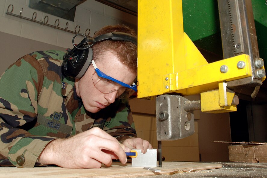 Cadet 1st Class Ian Helms fabricates an antenna bracket for FalconSat 5, part of the Department of Astronautics small satellite engineering program. The Department of Astronautics celebrated its 50th Anniversary March 7. Cadet Helms is with Cadet Squadron 22 at the U.S. Air Force Academy, Colo. (U.S. Air Force photo/Dave Armer)