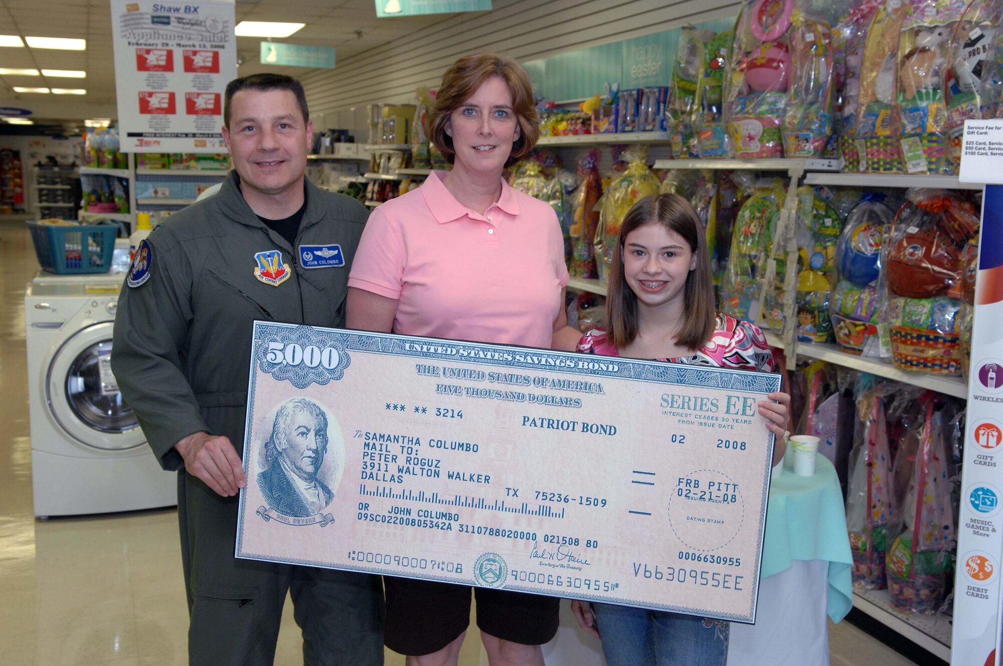 SHAW AIR FORCE BASE, S.C. -- Beth and Col. John Colombo, 20th Operations Group commander, pose for a picture with their daughter, Samantha, after she was presented a $5,000 U.S. savings bond March 6 at the base exchange from Col. Francis Xavier, 20th Mission Support Group commander, Maurice Joiner, BX general manager, and Jonathan Bright, BX Manager. Samantha earned the savings bond by winning first place in the AAFES "You Made the Grade" contest. (U.S. Air Force photo/Airman 1st Class Matthew Davis)