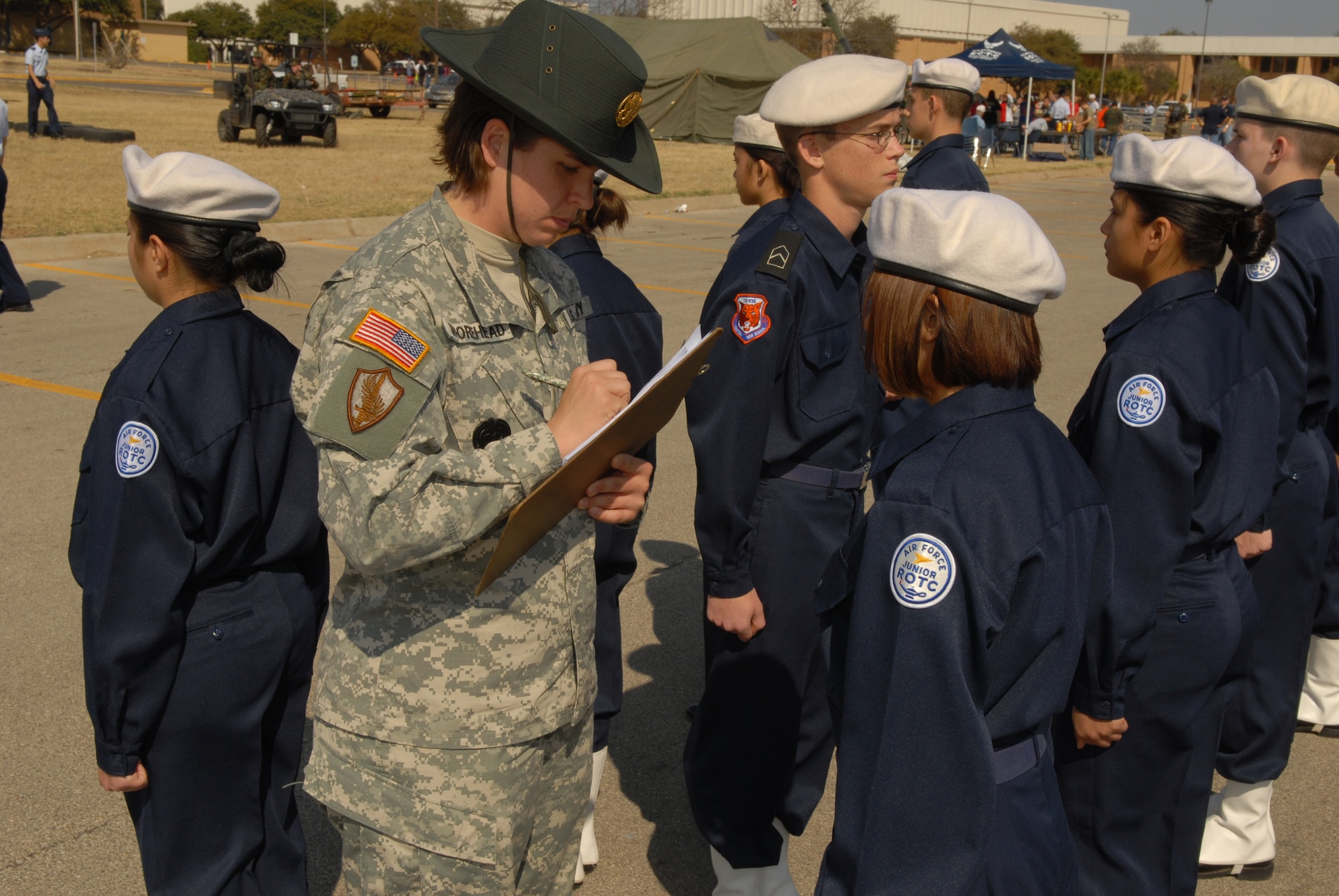 Army Sergeant First Class Debora Moorehead, a drill sergeant with the 344th Military Intelligence Battallion, critiques members of the Central High School Air Force Junior ROTC unit during the inspection portion of the drill meet March 2. Drill sergeants from the 344 MIBn were on hand to grade and advise the cadets during the competition. (U.S. Air Force photo by Staff Sgt. John Barton)