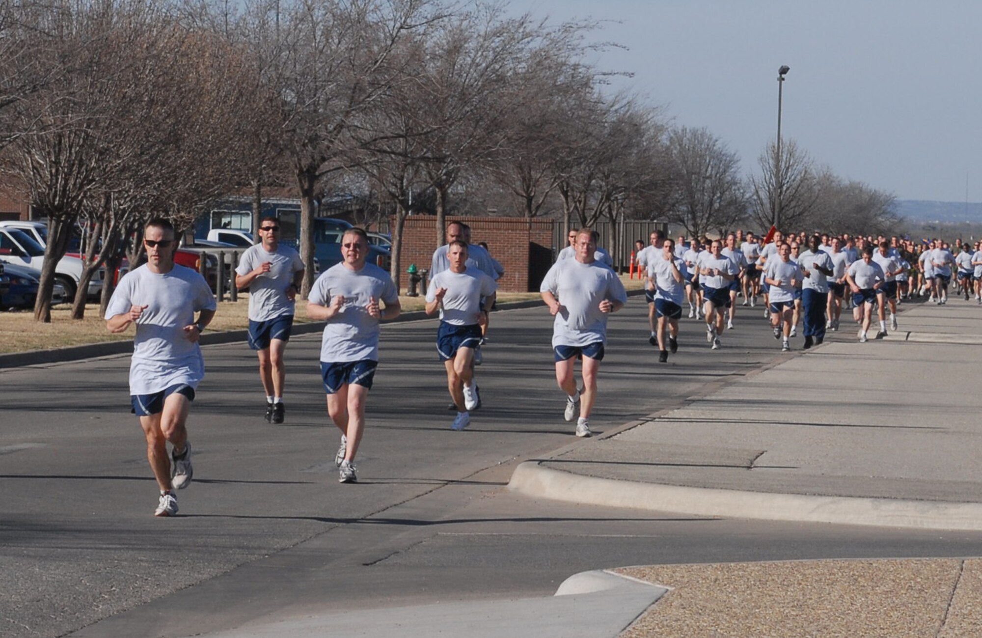Capt. Michael O’Mara (in front), a member of the 17th Training Wing legal office, followed by hundreds of other servicemembers take part in Goodfellow Air Force Base’s first Warrior Run for 2008. The Warrior Run, more commonly referred to as ‘The Wing Run,’ is an event that takes place two to four times a year and is coordinated by the staff of the Mathis Fitness Center. The event is designed to promote good, physical fitness, espirit de corps, and boost unit morale. The run was led by Col. Merrily Madero, 17th Training Wing vice commander. Airmen from the 17th Mission Support Group, 17th Medical Group, 17th Training Group and the Goodfellow NCO Academy all took part in the run. Soldiers from the 344th Military Intelligence Battalion, Sailors from the Center for Information Dominance and Marines from the Marine Corps Detachment also took part in the 2.2 mile run. (U.S. Air Force photo by Staff Sgt. Angela Malek.)