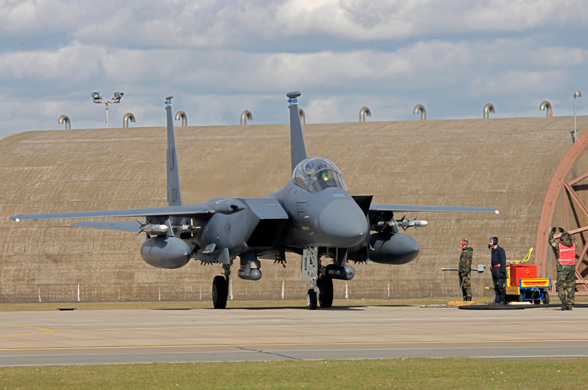 An F-15E Strike Eagle from the 492nd Fighter Squadron is marshaled into a hot pit refueling session March 3 at RAF Lakenheath. The hot pit allows crews to recover and launch aircraft at a faster pace, by refueling the aircraft while the engines are still running. (U.S. Air Force photo by Airman Perry Aston) 