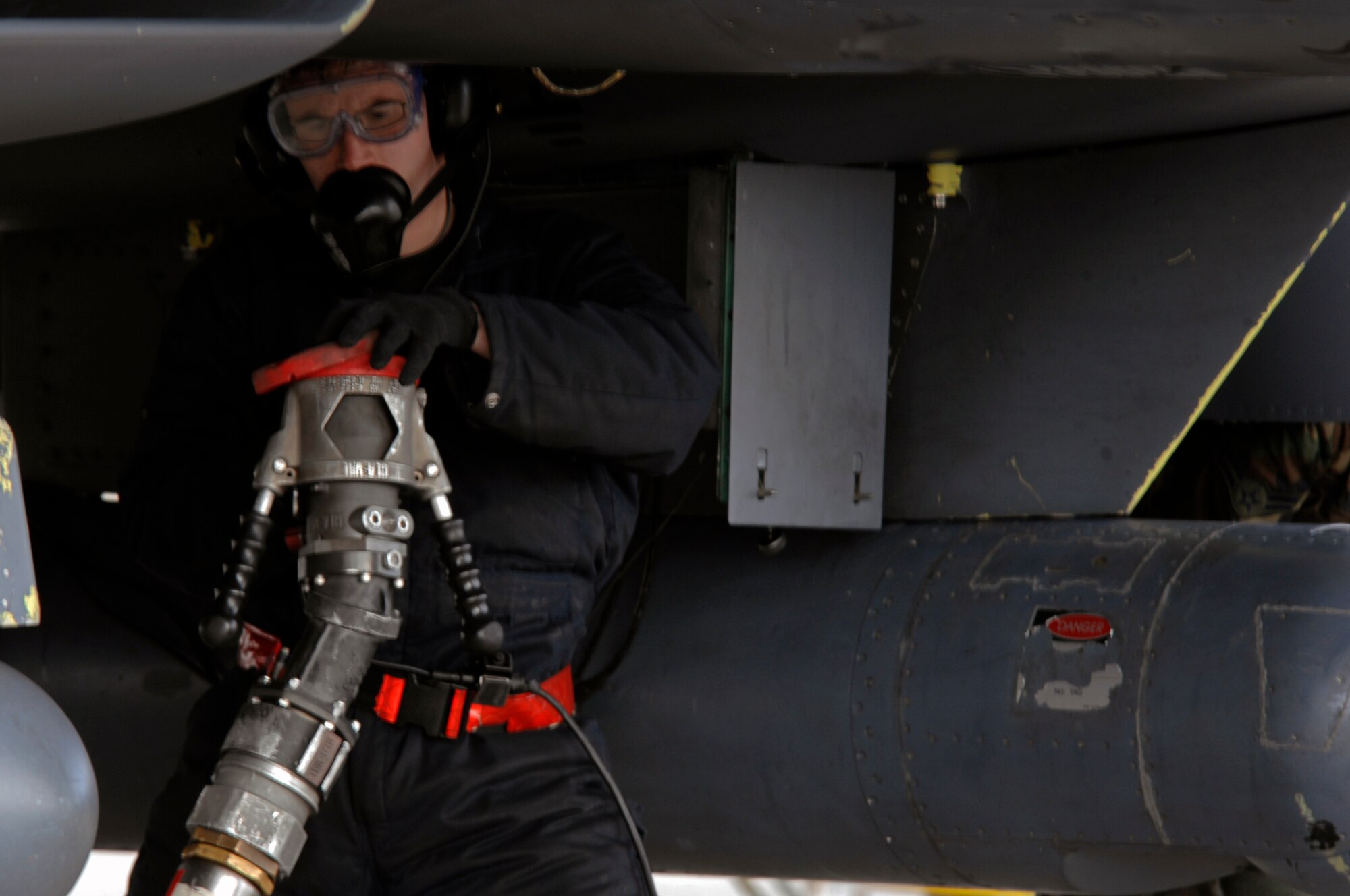 Airman 1st Class Stephen Smith, 48th Aircraft Maintenance Squadron crew chief, disconnects the nozzle from the F-15E during a hot pit refueling session, March 3 at RAF Lakenheath. To minimize ground time crews regularly perform hot pits to allow the aircraft to be refueled while the engines are running. (U.S. Air Force photo by Airman Perry Aston) 