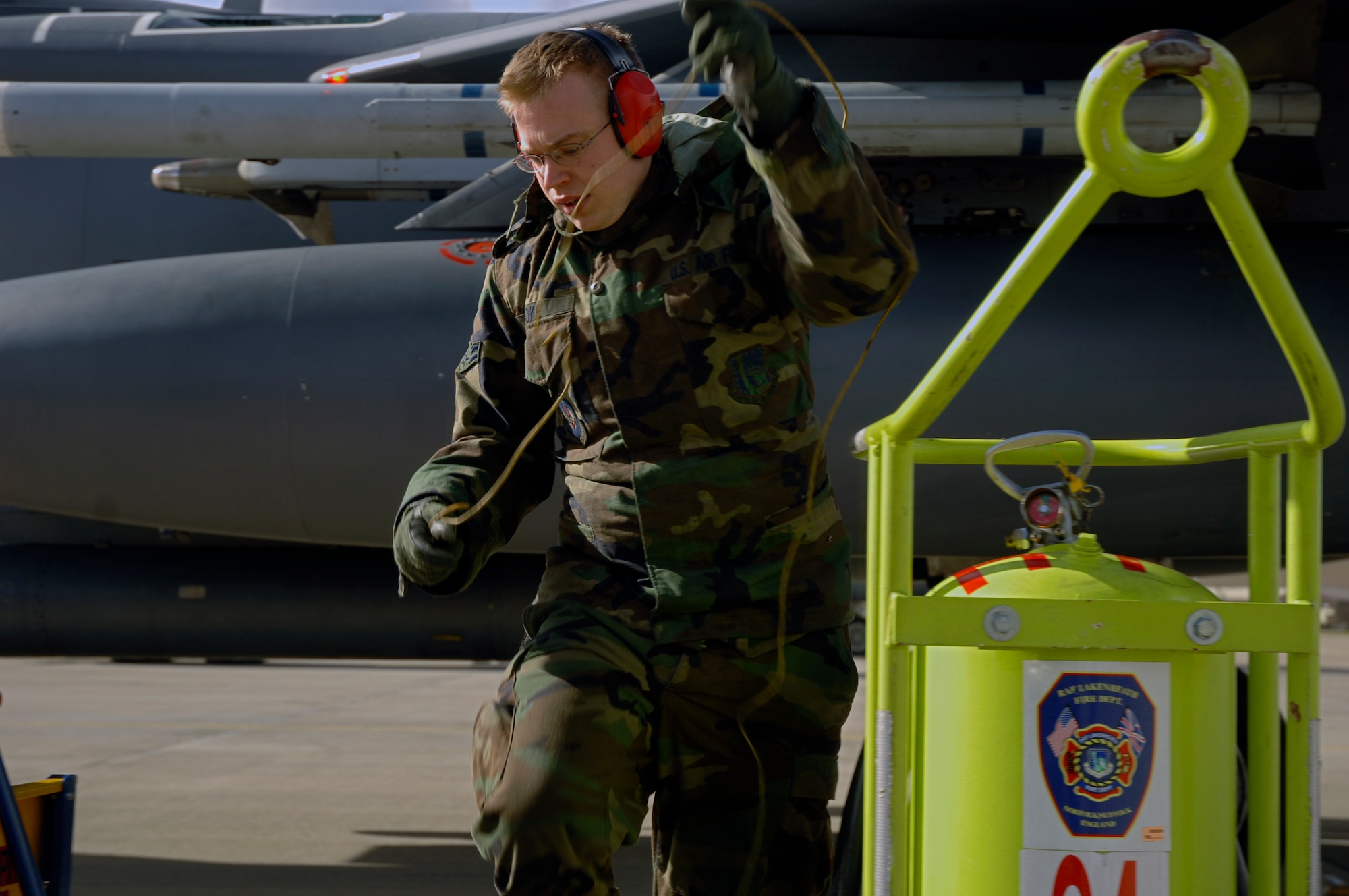 Airman 1st Class David Cooper, 48th Aircraft Maintenance Squadron electro-environmental technician, gathers the grounding wire for a fuels truck during a hot pit refueling session March.3 at RAF Lakenheath. The hot pit allows crews to recover and launch aircraft at a faster pace, by refueling the aircraft while the engines are still running. (U.S. Air Force photo by Airman Perry Aston) 