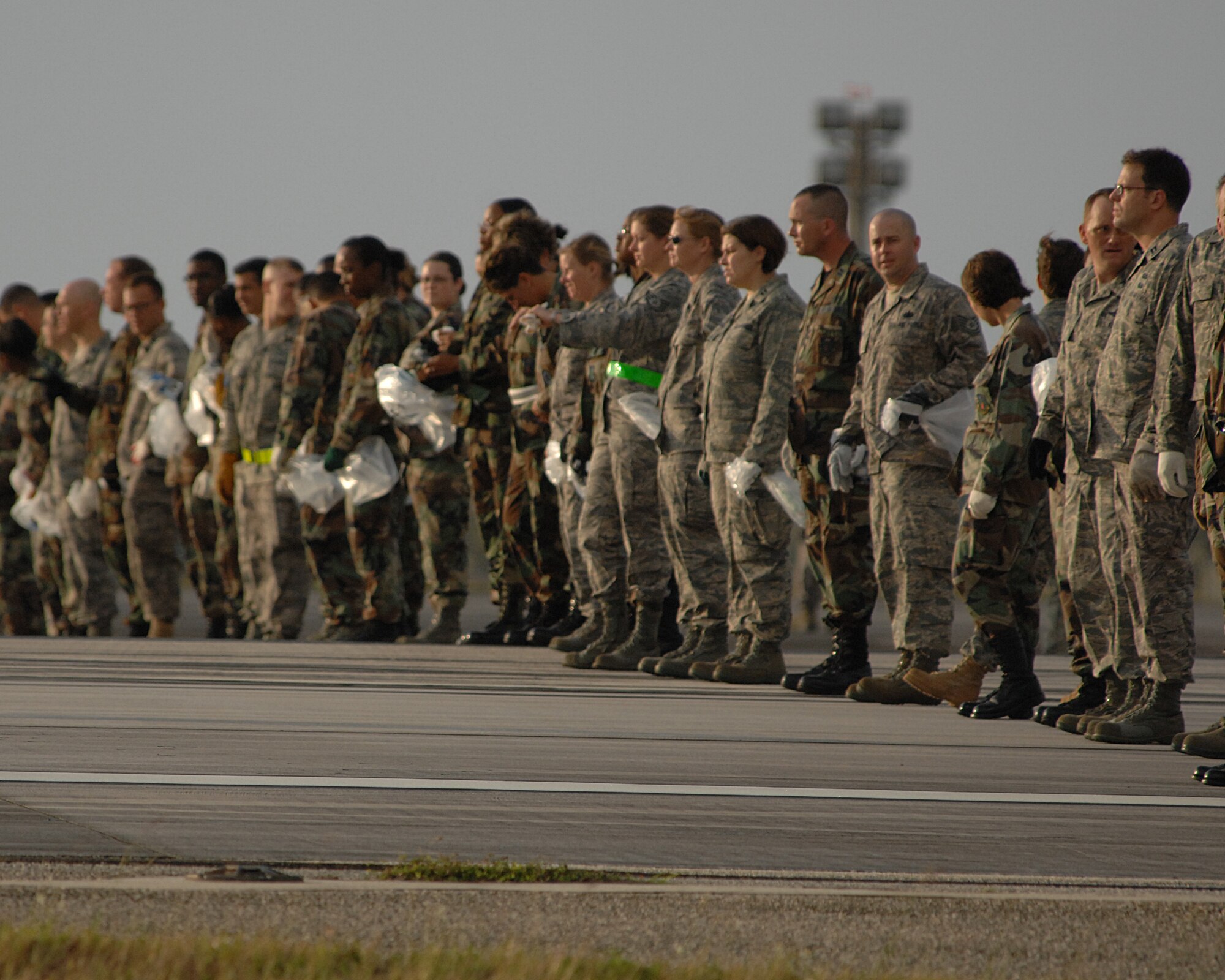ANDERSEN AFB, Guam-- Members of the 36th Wing line up to search the airfield for foreign object debris, or FOD.  The wing is clearing the airfield to re-open a runway that has been closed since a B-2 Spirit bomber crashed here. (U.S. Air Force Photo by Staff Sgt. Vanessa Valentine)
