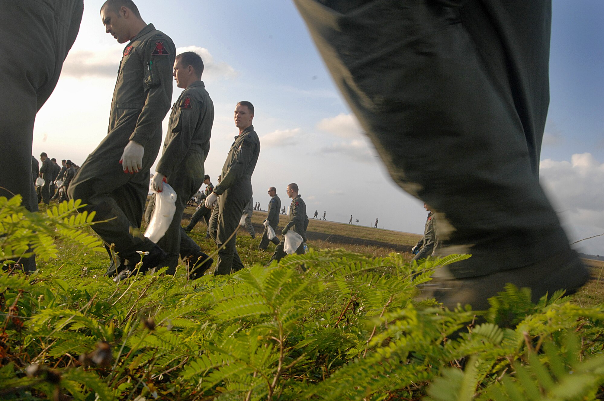 ANDERSEN AFB, Guam-- Members of the 96th Expeditionary Bomb Squadron scan the Andersen AFB's airfield for foreign object debris, or FOD.  The wing is clearing the airfield to re-open a runway that has been closed since a B-2 bomber crashed here. (U.S. Air Force Photo by Staff Sgt. Vanessa Valentine)
