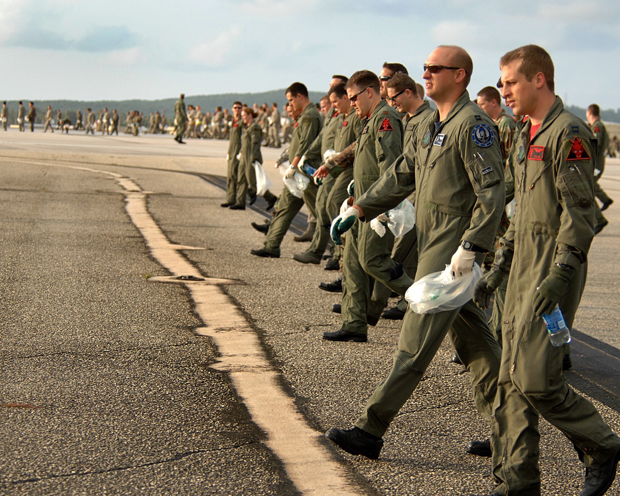 ANDERSEN AFB, Guam-- Members of the 96th Expeditionary Bomb Squadron join with Andersen AFB's 36th Wing to scan the airfield for foreign object debris, or FOD.  The wing is clearing the airfield to re-open a runway that has been closed since a B-2 bomber crashed here. The 96th EBS is deployed here from Barksdale AFB, La. (U.S. Air Force Photo by Staff Sgt. Vanessa Valentine)
