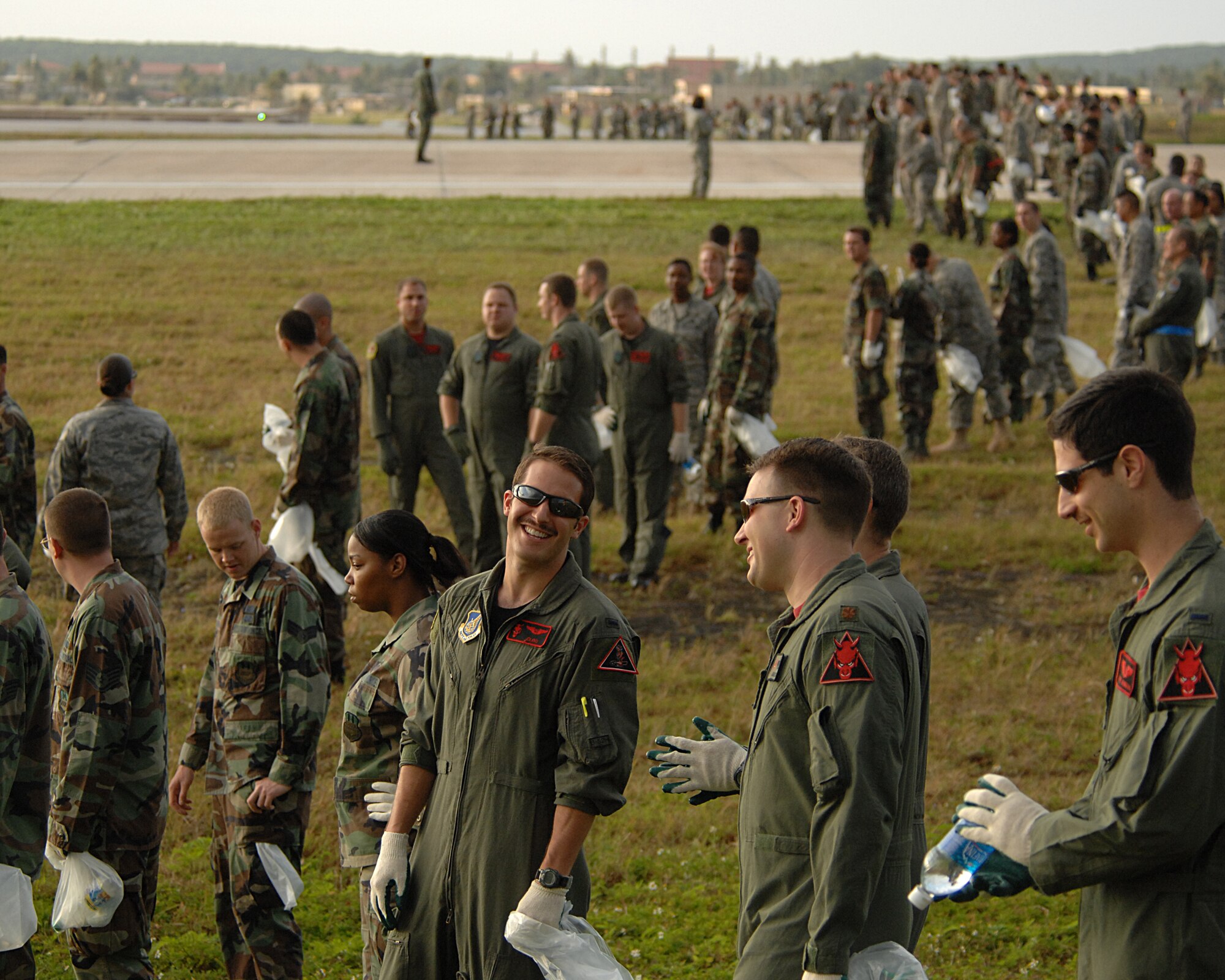 ANDERSEN AFB, Guam-- Members of the 96th Expeditionary Bomb Squadron join with Andersen AFB's 36th Wing to scan the airfield for foreign object debris, or FOD.  The wing is clearing the airfield to re-open a runway that has been closed since a B-2 bomber crashed here. The 96th EBS is deployed here from Barksdale AFB, La. (U.S. Air Force Photo by Staff Sgt. Vanessa Valentine