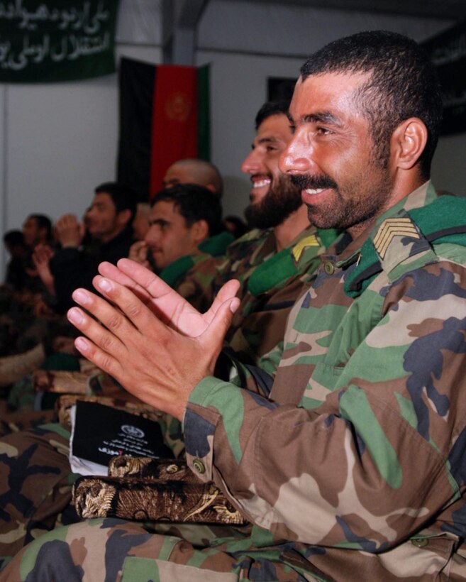 Afghan National Army soldiers clap and cheer for comrades graduating from the new Afghan Information Dissemination Operations course on Camp Clark, Afghanistan, Feb. 27, 2008. Photo by Spc. Micah E. Clare, USA
