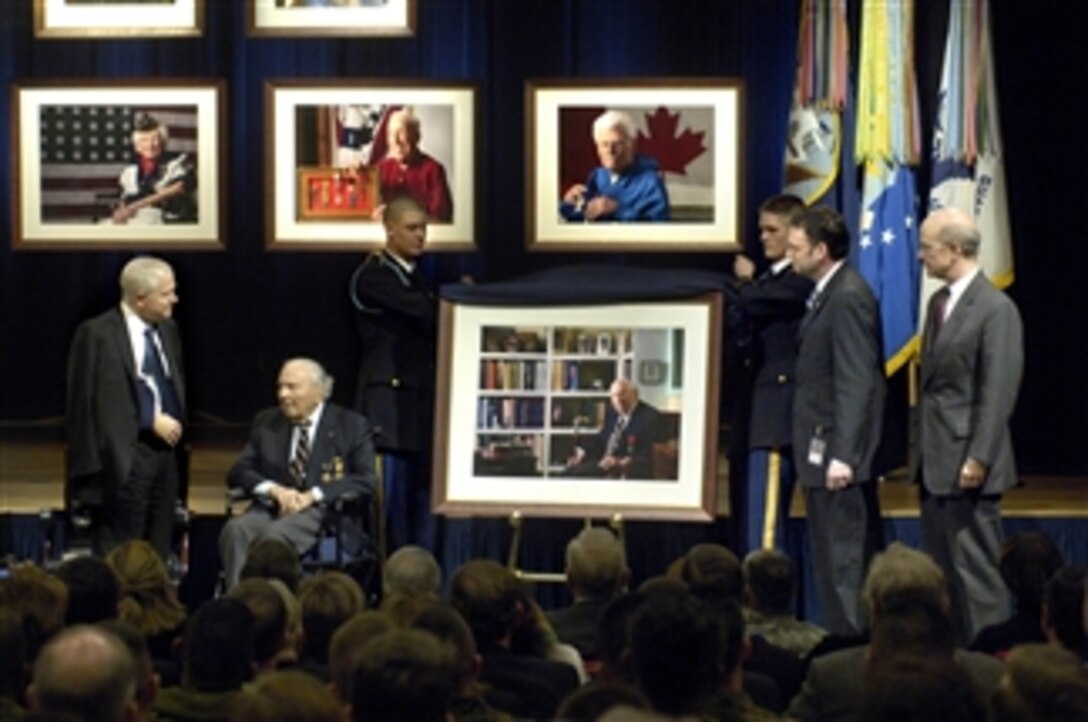 The portrait of WWI veteran Frank Buckles is unveiled during Pentagon ceremonies dedicating an exhibit of photography commemorating the last nine veterans who served in World War I on March 6, 2008.  Secretary of Defense Robert M. Gates (left) stands beside the 107 year-old Buckles, a veteran of both WWI and WWII. Secretary of the Army Pete Geren (right) stands with the photographer David DeJonge (2nd from right).  Since the start of the photo project, seven of the veterans have passed away leaving only Buckles and John Babcock, who served with the Canadian forces in WWI, and was unable to attend the ceremony.  