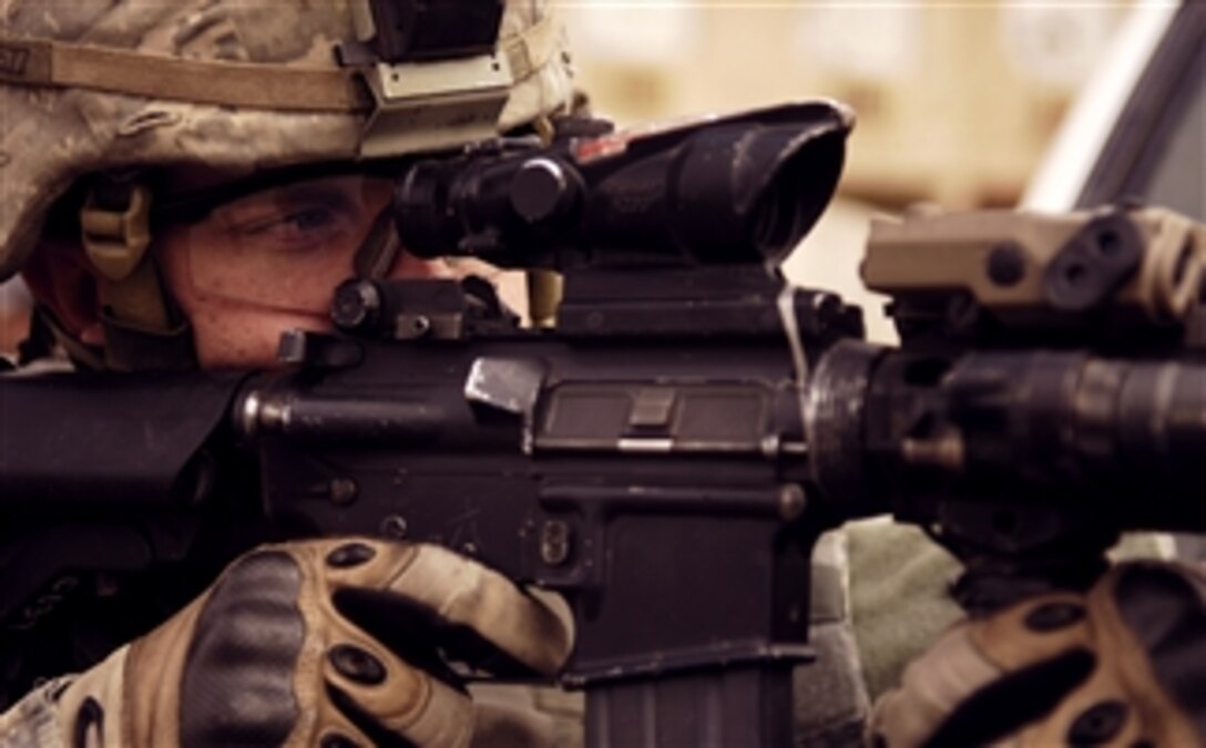 U.S. Army Staff Sgt. Josh Everett provides security at an Iraqi National Police traffic checkpoint during a presence patrol in Baghdad, Iraq, Feb. 29, 2008. Everett is assigned to the 4th Infantry Division's 1st Battalion, 68th Armor Regiment.