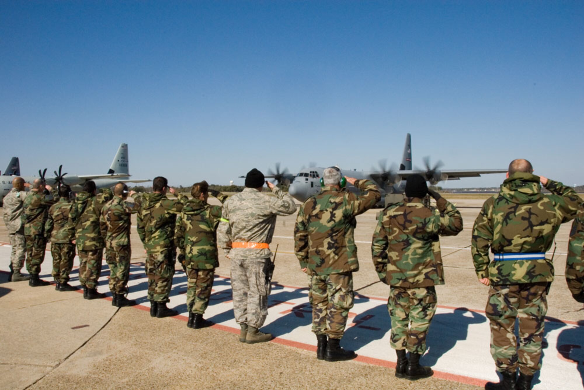 KEESLER AIR FORCE BASE, Miss.--Maintaintainers salute fellow members of the 403rd Wing who are aboard the "Spirit of Bilioxi" a C-130J-30 headed for Southwest Aisa. The aircraft was dedicated to the city of Biloxi in 2006. As the troops begin their mission in support of the Global War on Terror, the noseart on this aircraft symbolizes the bond between the community and the  Citizen Airmen. (U.S. Air Force Photo/Tech. Sgt. James B. Pritchett)