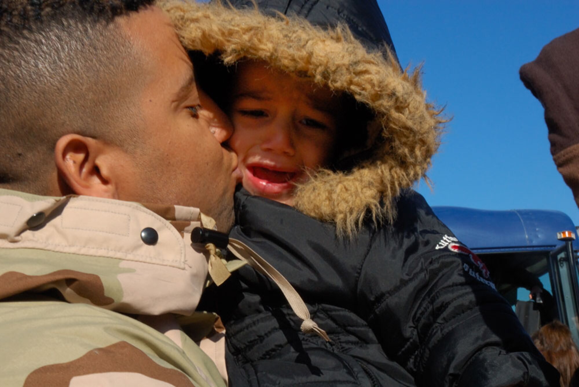 KEESLER AIR FORCE BASE, Miss.-- Master Sgt, Rafael Gonzalez kisses his son goodbye before boarding a C-130J-30 bound for Southwest Asia in support of the Global War on Terror. Sergeant Gonzalez is a client support technician assigned to the 403rd Communications Flight. The 403rd Wing deployed two of its tactical airlift aircraft assigned to the 815th Airlift Squadron along with more than 60 Citizen Airmen this morning. (U.S. Air Force Photo/Tech. Sgt. James B. Pritchett)