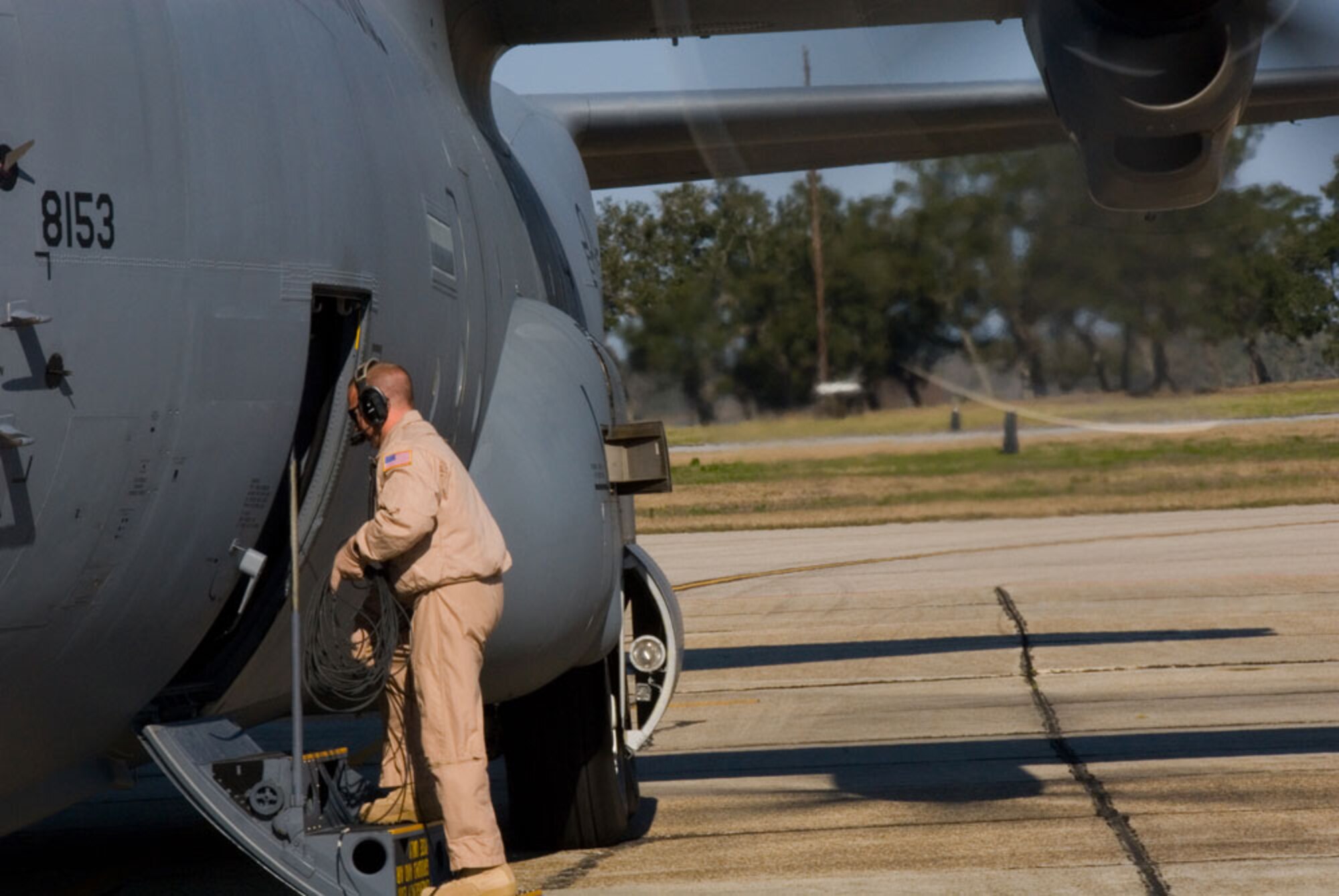 KEESLER AIR FORCE BASE, Miss.--Boarding a C-130J-30 Super Hercules bound for Southwest Asia, Tech. Sgt. Troy Peltier, loadmaster, prepares to button up the crew entrance door before takeoff. Sergeant Peltier joined Citizen Airmen of the 815th Airlift Squadron, 403rd Manintenance Group and other support personnel from the 403rd Wing as they deployed this morning in support of the Global War on Terror. (U.S. Air Force Photo/Tech. Sgt. James B. Pritchett)