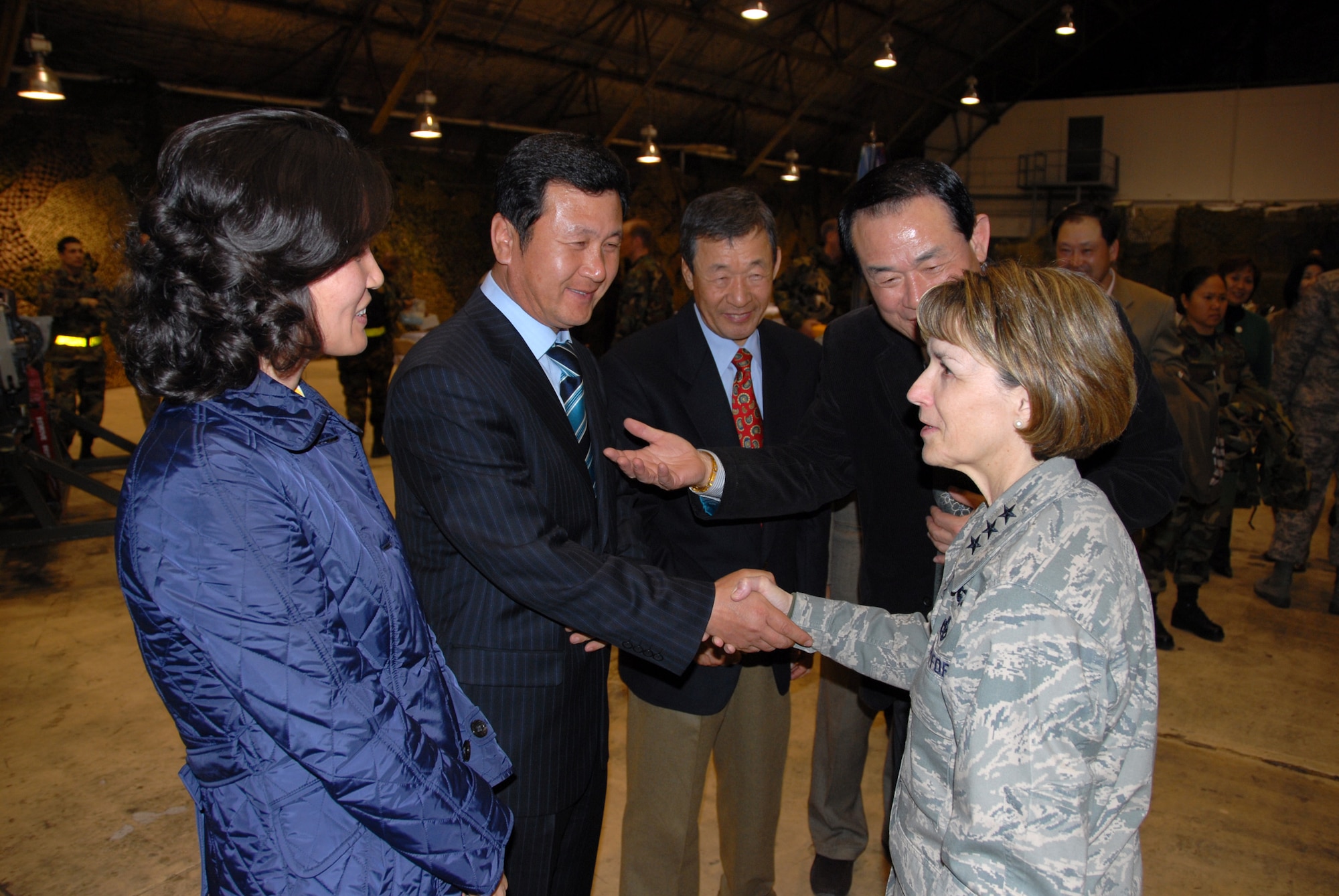 OSAN AIR BASE, Republic of Korea—Lt. Gen. Terry L. Gabreski, Air Force Materiel Command vice commander, and guest speaker at the 51st Fighter Wing’s Maintenance Professional of the Year banquet, greets Osan Air Base’s “Honorary commanders” who attended the banquet.  During her speech to attendees, General Gabreski said it was important for aircraft maintainers to exhibit Air Force core values when performing their daily missions of aircraft generation. When pilots perform a walk-around inspection of their aircraft, they finish by reviewing the aircraft forms, checking for the "X" and crew chief's signature certifying that the aircraft is ready for flight. The "X" and signature on the forms also signify the aircraft crew chief's integrity and provides a mutual bond of trust between the crew chief and the pilot, said the general.  Additionally, General Gabreski presented Maintenance Professional of the Year awards to 51st Maintenance Group Airmen.  (U.S. Air Force photo/Senior Master Sgt. Marvin Krause)