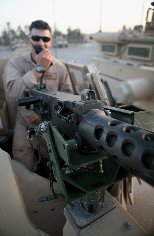 Cpl. Matthew J. Dombrowski, 22, from Hammond, Ind., checks his handheld radio before departing Camp Fallujah Mar. 8. He is currently deployed with Security Company, Combat Logistics Battalion 1, 1st Marine Logistics Group, and is a scout gunner with 1st Squad, 1st Platoon. The company provides security for military and civilian convoys, vehicle-recovery missions and Explosive Ordnance Disposal (EOD) team operations. They also conduct mounted security patrols and have formed a personal security detachment for the battalion's commanding officer and V.I.P.'s visiting the base. A majority of the Marines and Sailors are stationed in Camp Pendleton, Calif., and are scheduled to return to the United States summer 2008.