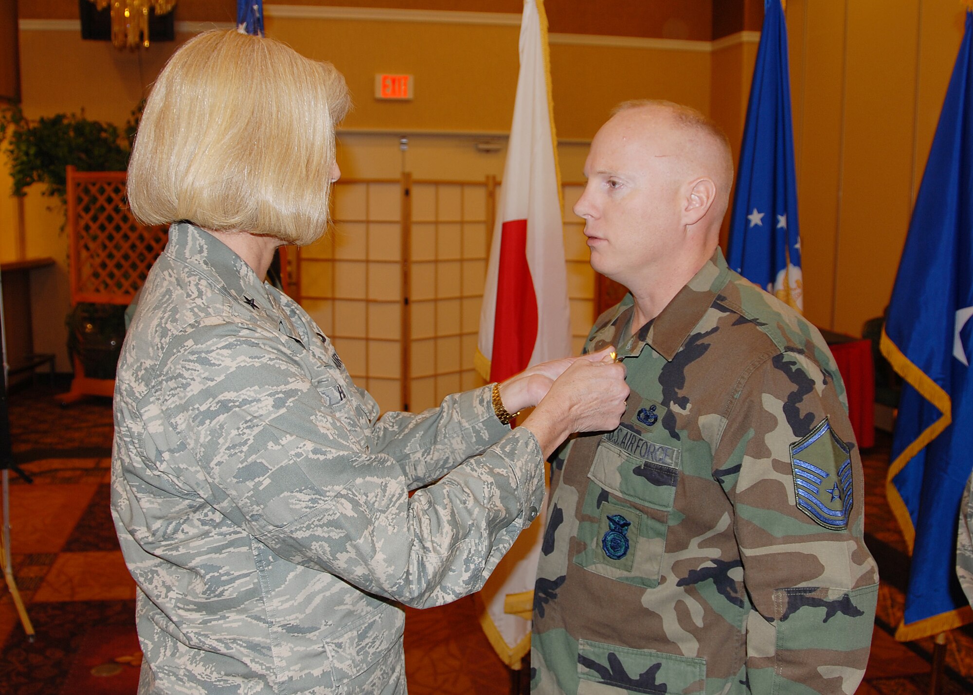 MISAWA AIR BASE, Japan -- Brig. Gen. Mary Kay Hertog, Director of Security Forces, pins the bronze star on Master Sgt. Keith Elston, 35th Security Forces Squadron. Sergeant Elston received the bronze star for his actions while deployed supporting detainee operations at Camp Bucca, Iraq. (U.S. Air Force photo by Senior Airman Chad Strohmeyer)