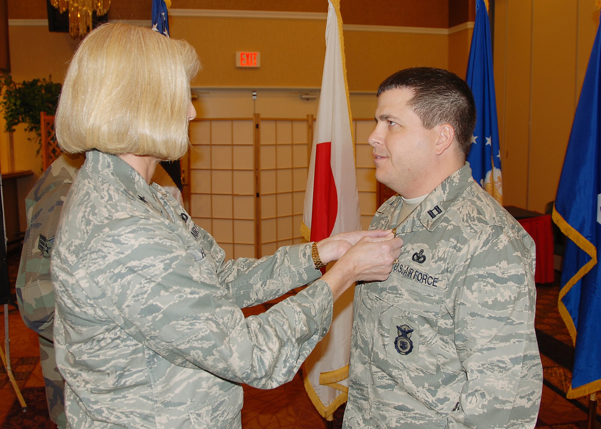 MISAWA AIR BASE, Japan -- Brig. Gen. Mary Kay Hertog, Director of Security Forces, pins the bronze star on Capt. Jeffery Day, 35th Security Forces Squadron. Captain Day received the bronze star for his actions while deployed supporting detainee operations at Camp Bucca, Iraq. (U.S. Air Force photo by Senior Airman Chad Strohmeyer)