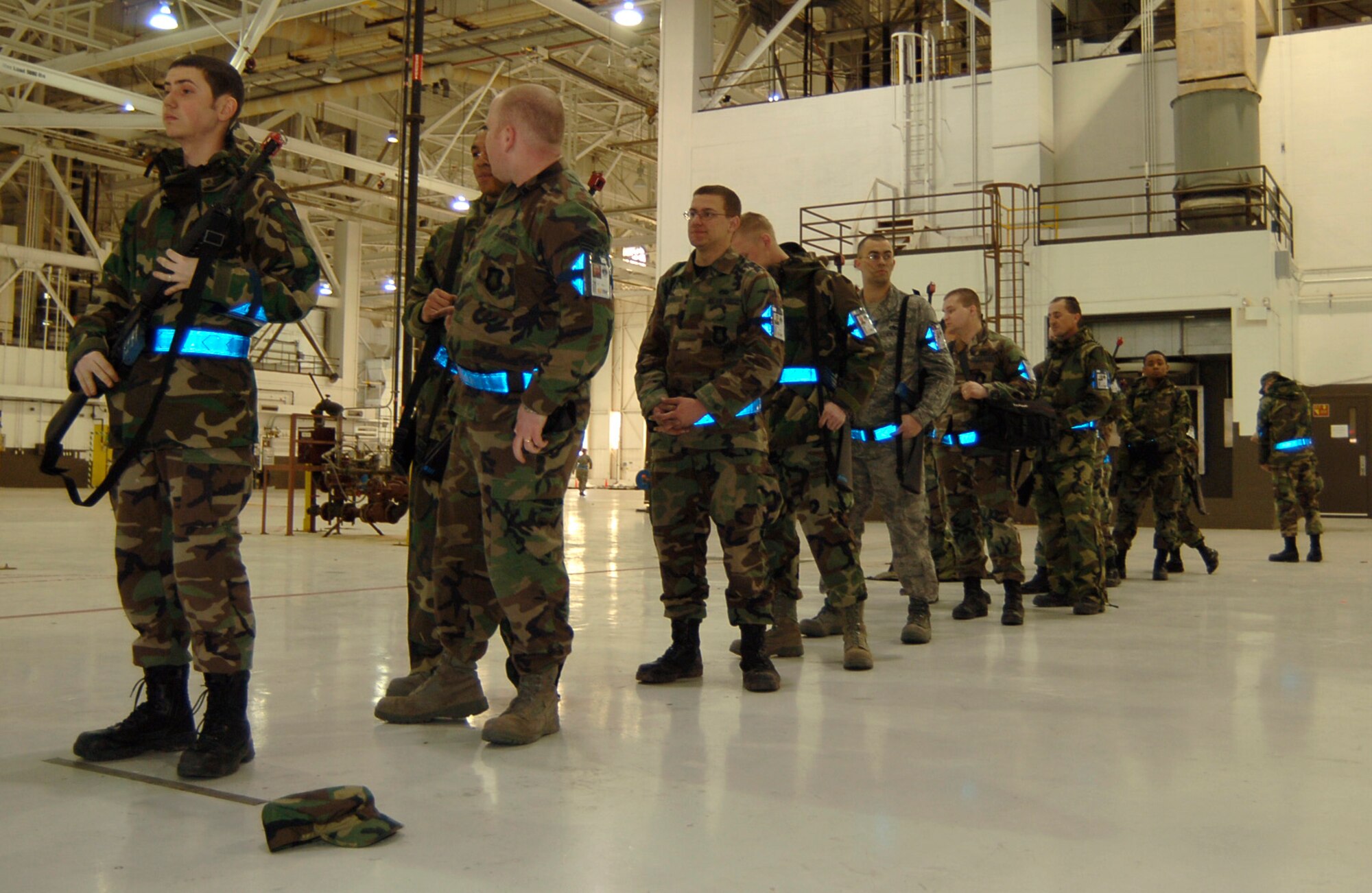 MCCONNELL AIR FORCE BASE, Kan. -- Members from the 22nd Air Refueling Wing and reservists from the 931st Air Refueling Group wait in line to safety clear their M-16’s in Hanger 1107, March 8, during an Ability to Survive and Operate exercise. (Photo by Airman 1st Class Maria Ruiz)