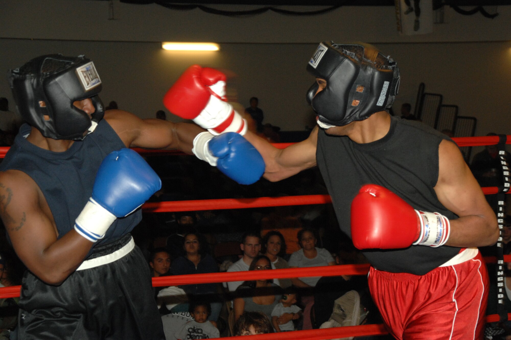 Airman 1st Class Daniel Monroe and Senior Airman Darius Jones, both of the 49th Operations Support Squadron, go toe to toe during a Raptor Rumble match March 7 at Holloman Air Force Base, N.M. The two, whose hometowns are both  in Virginia, fought in the 162 lb. division. (U.S. Air Force photo/Airman 1st Class Jamal D. Sutter)