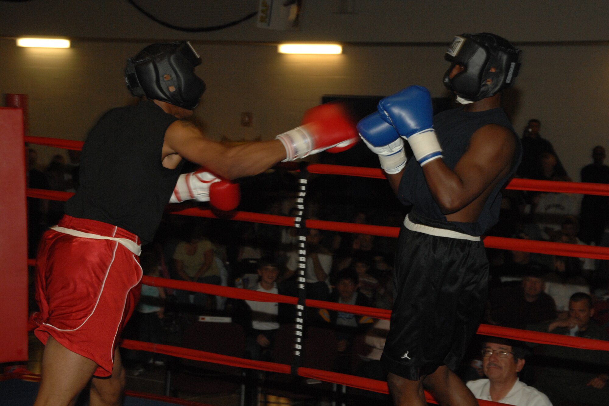 Airman 1st Class Daniel Monroe and Senior Airman Darius Jones, both of the 49th Operations Support Squadron, go toe to toe during the Raptor Rumble March 7 at Holloman Air Force Base, N.M. The two, whose hometowns are both  in Virginia, fought in the 162 lb. division. (U.S. Air Force photo/Airman 1st Class Jamal D. Sutter)