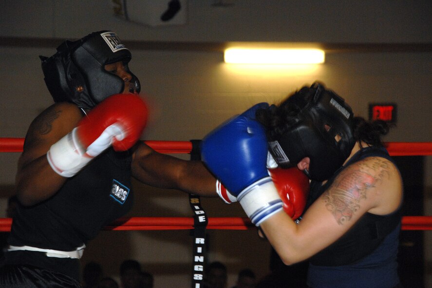 Staff Sgt. Genese Williams, 49th Materiel Maintenance Support Squadron, jabs Airman 1st Class Krystal Macatol, 49th Maintenance Squadron, during the Raptor Rumble March 7 at Holloman Air Force Base, N.M. Sergeant Williams won the three round fight by decision. (U.S. Air Force photo/Airman 1st Class Jamal D. Sutter)