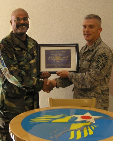 NELLIS AIR FORCE BASE, Nev. - Master Sgt. Rickie Webb, “Touch and Go” Flight Kitchen dining facility manager, on behalf of his staff, receives the 99th Air Base Wing Command Chief Master Sgt. Robert Brooks’ monthly STAR award at the Flight Kitchen here March 6. The Flight Kitchen personnel earned the award for their excellent work ethics.