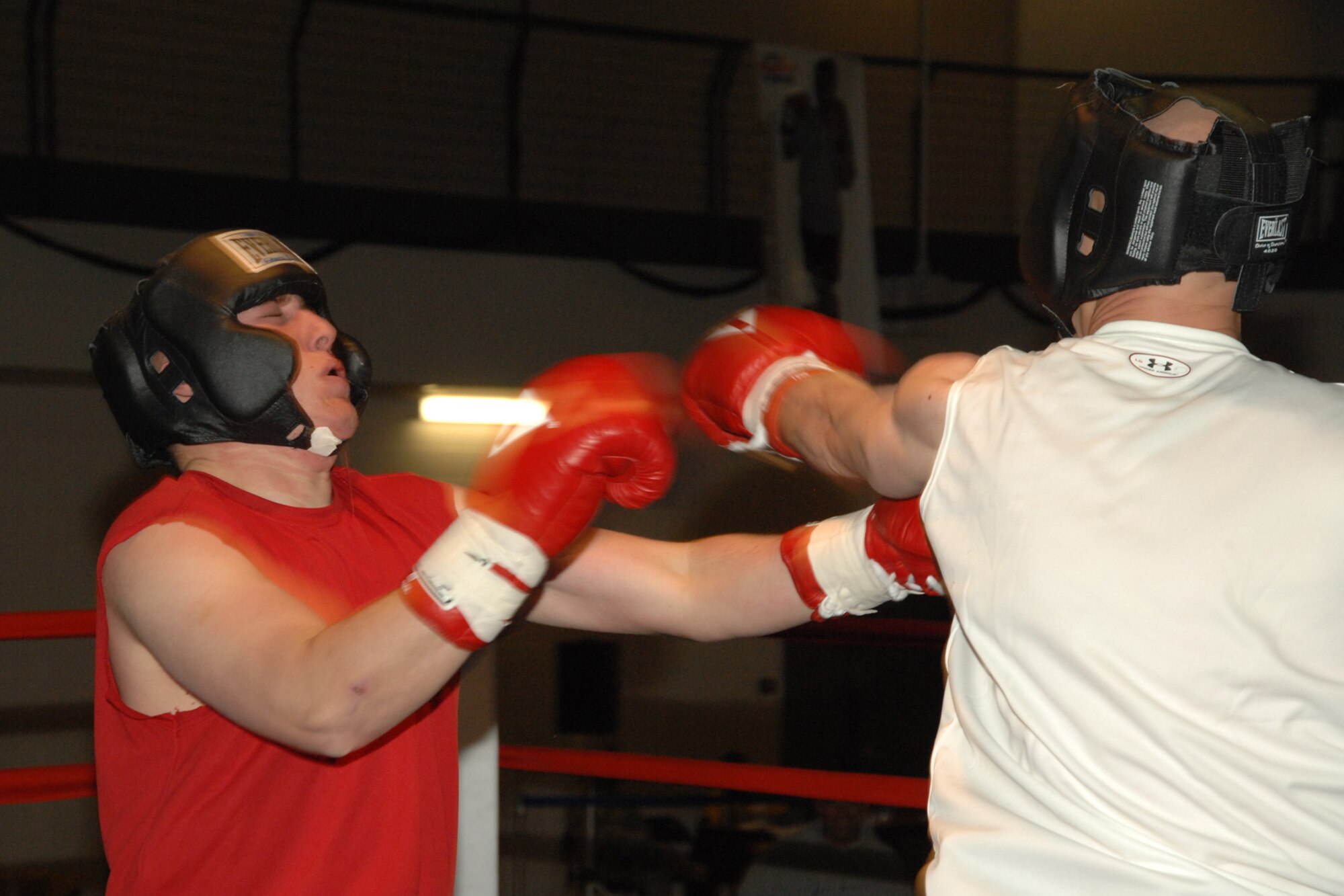 Airman 1st Class Arien Goldman is stunned by a left jab from Staff Sgt. Jason Scheunemann during a Raptor Rumble match March 7 at Holloman Air Force Base, N.M. Both, who fought in the 185 lb. division,  are from the 49th Maintenance Squasron. (U.S. Air Force photo/Airman 1st Class Jamal D. Sutter)