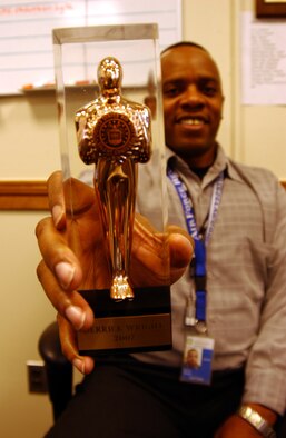 ANDREWS AIR FORCE BASE, Md. -- Master Sgt. Derrick Wright, 459th Aeromedical Evacuation Squadron training manager, holds up his Golden Roger award in the public affairs office Jan. 20. (U.S. Air Force photo/Staff Sgt. Amaani Lyle)                              