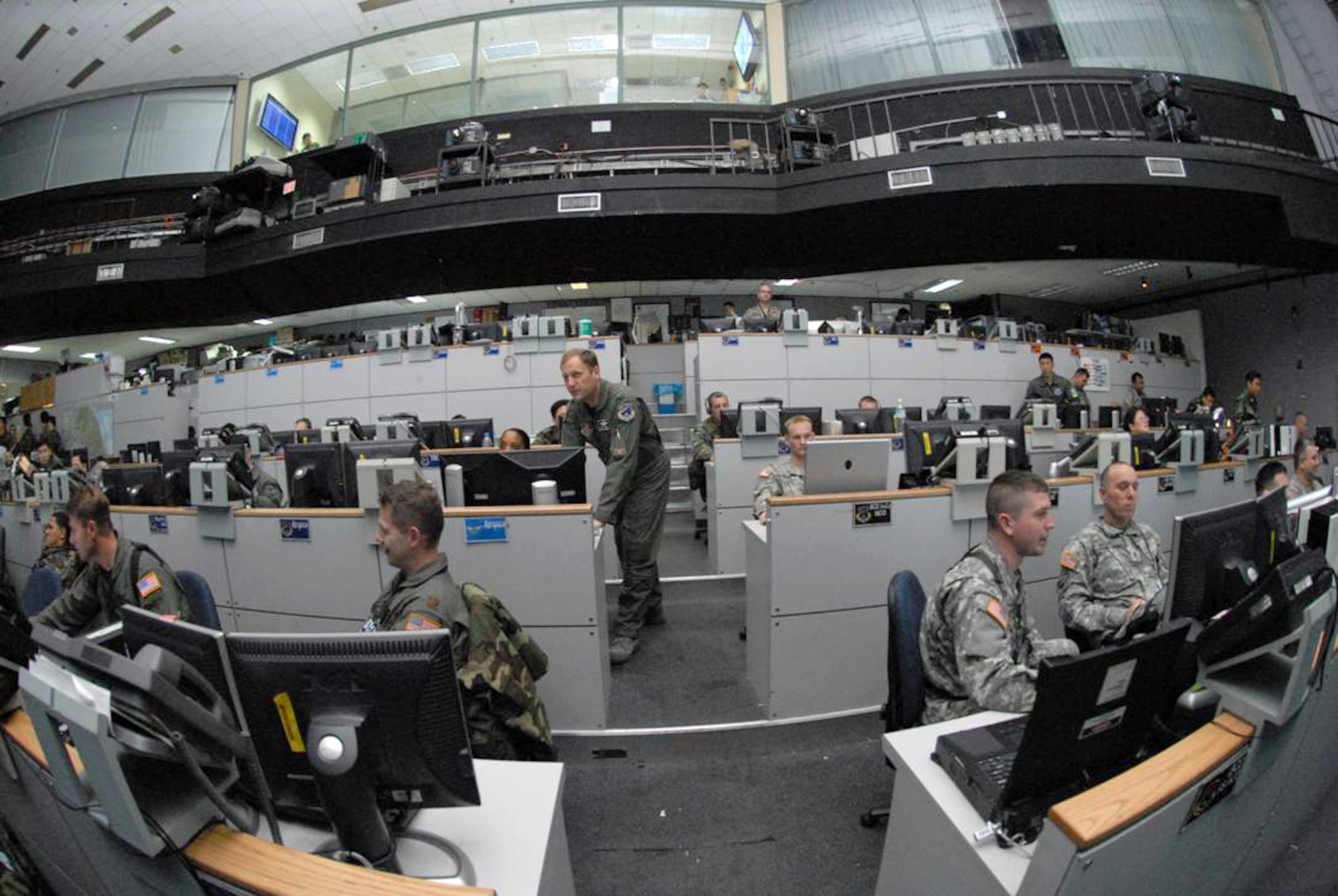 Col. Rob Kyrouac, (center), leads members on the "pit floor" of the Korean Air Operations Center during Exercise Key Resolve March 2-7. Key Resolve is an "operational-level," Republic of Korea-U.S. training exercise held peninsula-wide to ensure operational readiness of air, space and cyberspace operations in the Korean theater of operations. This annual exercise is in conjunction with Foal Eagle 2008. Both exercises demonstrate U.S. resolve to support the Republic of Korea against external aggression while improving ROK/U.S. combat readiness and joint/combined interoperability. Colonel Kyrouac is the 607th Air and Space Operations Center chief of combat operations division. (U.S. Air Force photo/Staff Sgt. Lakisha Croley) 
