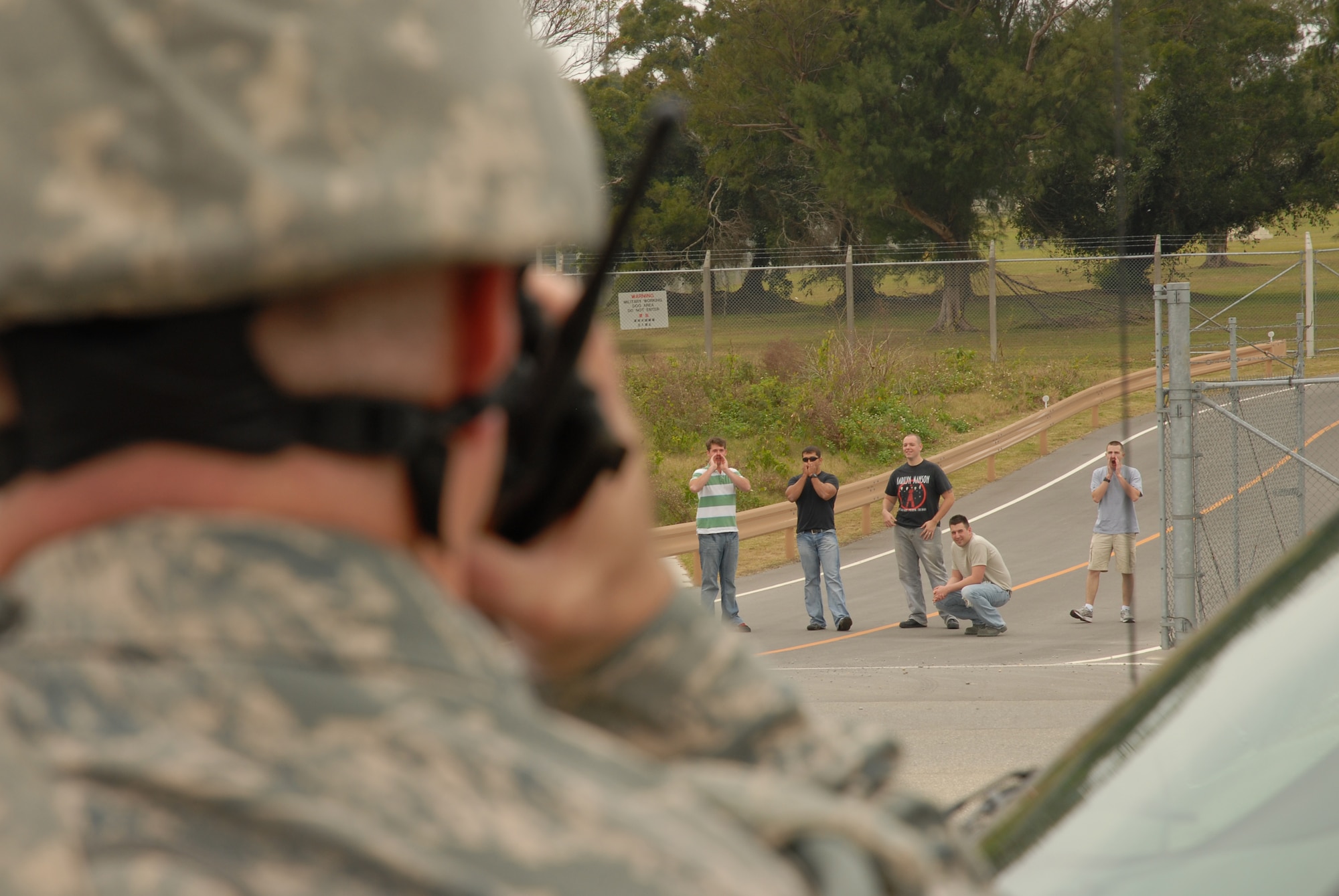 Lt. Col. Greg Foster, 18th Security Forces Squadron commander, calls the description of the protesters to the law enforcement desk before determining what course of action he will enforce during the 2008 Pacific Air Forces Operational Readiness Inspection at Kadena Air Base, Japan, March 10, 2008. PACAF is conducting the inspection from March 9 to 15 to validate the mission readiness of the 18th Wing. (U.S. Air Force photo/Staff Sgt. Chrissy FitzGerald)