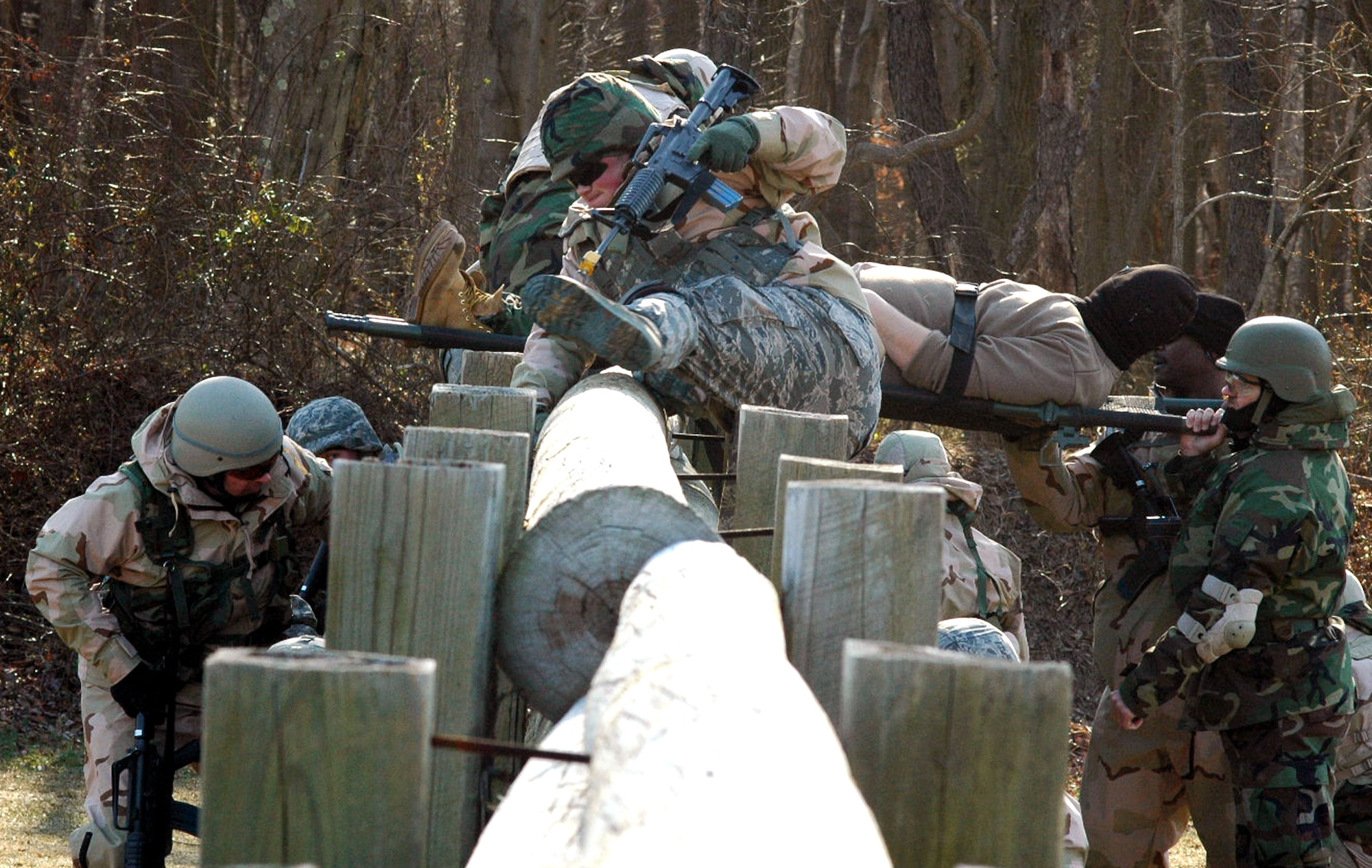 Students go through the combat first aid obstacle course Feb. 29 on a range on Fort Dix, N.J. Taught by Expeditionary Operations School officials, Air Force Expeditionary Center's Air Advisor Course 08-1 prepares Airmen deploying to Afghanistan and Iraq who will in turn be training military forces in those countries. (U.S. Air Force photo/Tech. Sgt. Scott T. Sturkol) 
