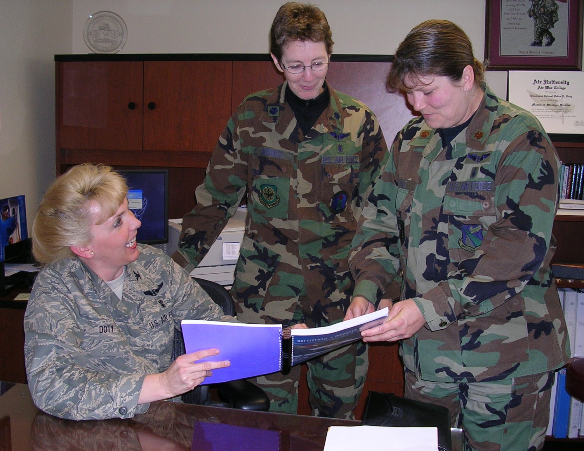 From left, Col. Debra Doty, 88th Medical Group, chief nurse at Wright-Patterson Medical Center; Dr. (Col.) Elizabeth Bridges, an Air Force Reserve nurse, University of Washington principal investigator and study overseer; and Maj. Joyce Hale, the base’s medical inpatient unit flight commander, discuss the results of a study involving the use of Meti-man, a human patient simulator, in training nurses. The study showed that Meti-man significantly increases a nurse’s ability to think critically and to manage trauma patients effectively in high stress situations. The study also showed that the comfort level in the experimental group was considerably higher after the training. (Air Force photo by Mike Frangipane)
 

