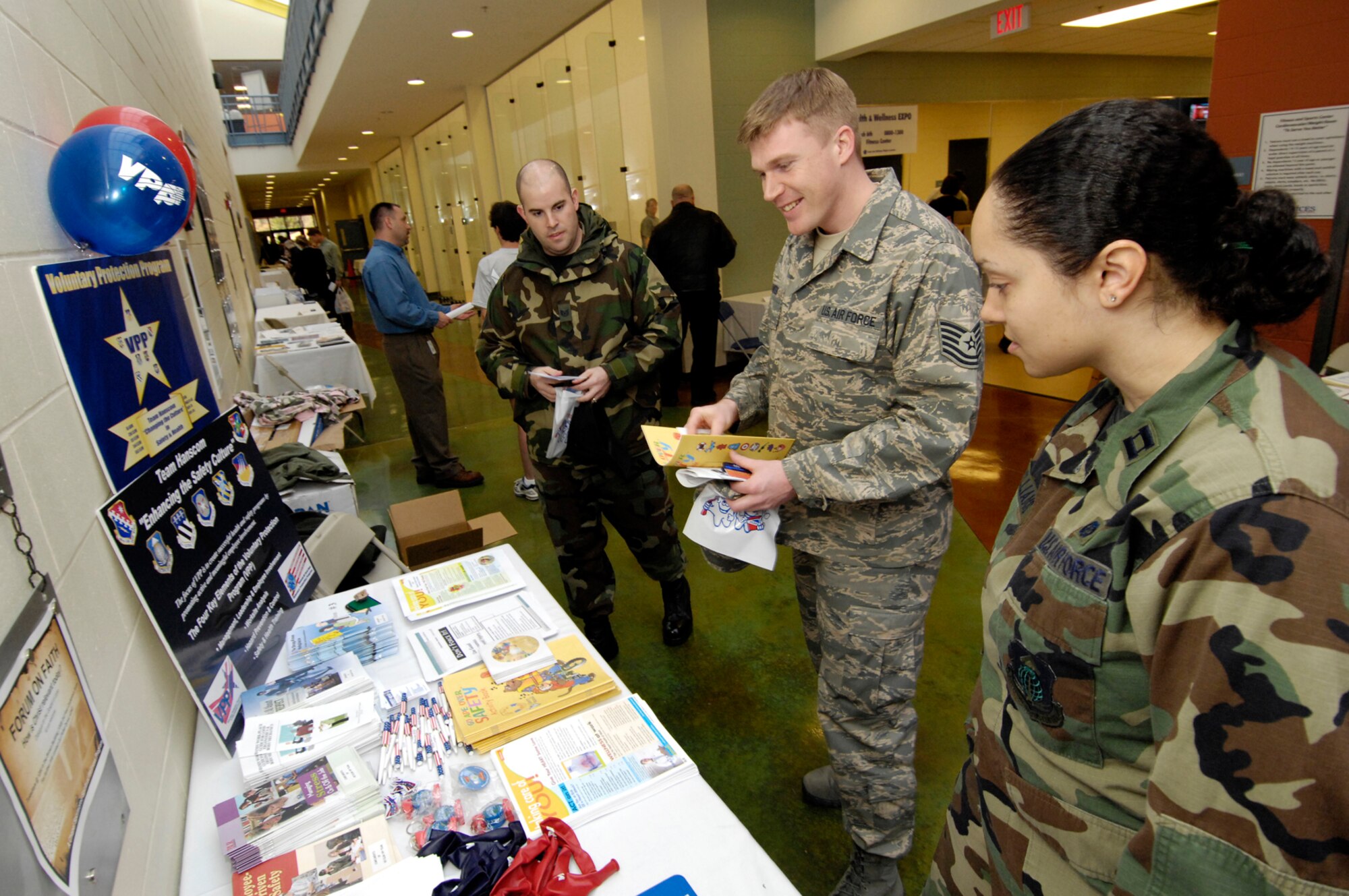 HANSCOM AFB, Mass. –Tech. Sgt. Kristopher Provencher (left) and Tech. Sgt. John Hunter (center) speak with Capt. Judith Williams (right) about the Voluntary Protection Program during the TLC Health Expo and Voluntary Protection Program Fair on March 6 at the Fitness and Sports Center. The event featured a number of information booths covering a broad spectrum of health and wellness issues. (U.S. Air Force photo by Mark Wyatt)

 

