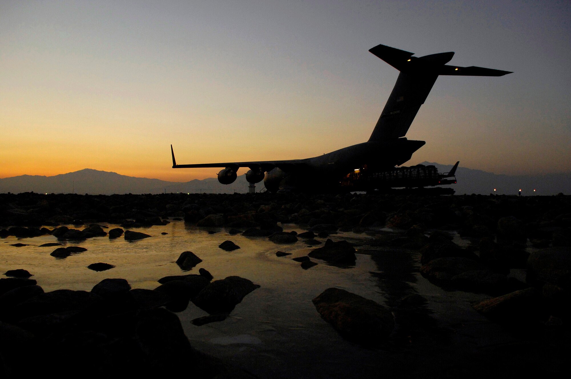 A C-17 Globemaster III is loaded with bundles for a Joint Precision Airdrop Delivery System of 40 bundles of humanitarian supplies recently at Bagram Air Base, Afghanistan. C-17s and C-130 Hercules aircraft flew approximately 141 airlift sorties, delivered 700 tons of cargo and transported 3,543 passengers March 9. (U.S. Air Force photo/Master Sgt. Andy Dunaway) 