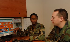 LANGLEY AIR FORCE BASE Va. -- Staff Sgts. Marquis Echols (left) and Kevin Hummel, Langley dorm managers, discuss the unit integrity plan for Cunningham Hall. Within the next year, about 30 percent of Airmen living in the dorms will move based on a concept called unit integrity. According to Air Force Instruction 32-6005, unit integrity groups squadron members into dormitories  based on the size of the squadron and where they would fit best. (U.S. Air Force photo/Airman 1st Class Aaron Johnson)
