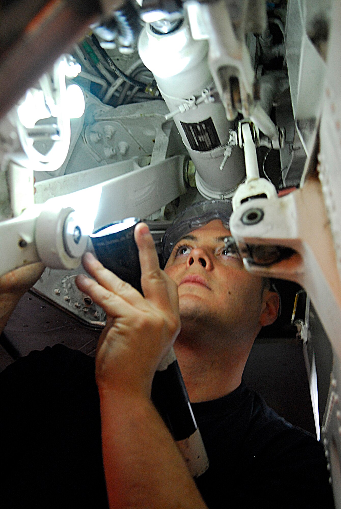 Staff Sgt. Jim Eckles, 67th Aircraft Maintenance Unit, inspects the left strut of an F-15 Eagle for servicing during the 2008 Pacific Air Forces Operational Readiness Inspection at Kadena Air Base, Japan, Mar. 10, 2008. PACAF conducted the inspection from Mar. 9 to 15 to validate mission readiness of the 18th Wing. (U.S. Air Force photo/Staff Sgt. Joshua J. Garcia)

