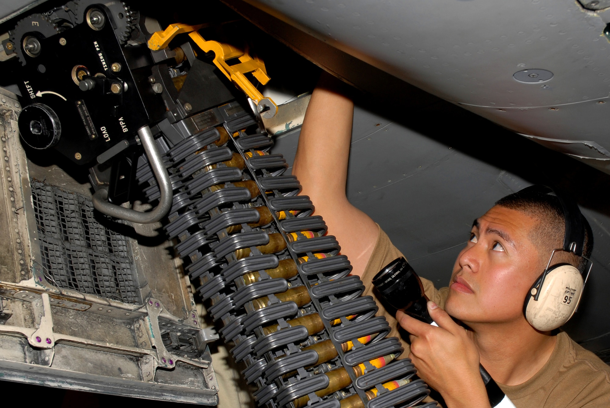 Staff Sgt. Jamie Vergara, 18th Aircraft Maintenance Squadron, watches for jams as the 20mm ammo goes through the linkless ammunition loading system into the F-15C, during the 2008 Pacific Air Forces Operational Readiness Inspection at Kadena Air Base, Japan, March 10, 2008. PACAF is conducting the inspection from March 9 to 15 to validate the mission readiness of the 18th Wing. (U.S. Air Force photo/Staff Sgt. Chrissy FitzGerald)

