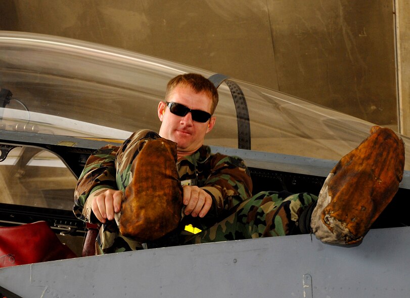 Staff Sgt. Kevin Cumbie, 18th Aircraft Maintenance Squadron, puts on booties prior to walking on the F-15C to perform a maintenance check, during the 2008 Pacific Air Forces Operational Readiness Inspection at Kadena Air Base, Japan, Mar 10. PACAF is conducting the inspection from Mar 9-15 to validate the mission readiness of the 18th Wing. (U.S. Air Force photo/Staff Sgt. Chrissy FitzGerald) 
