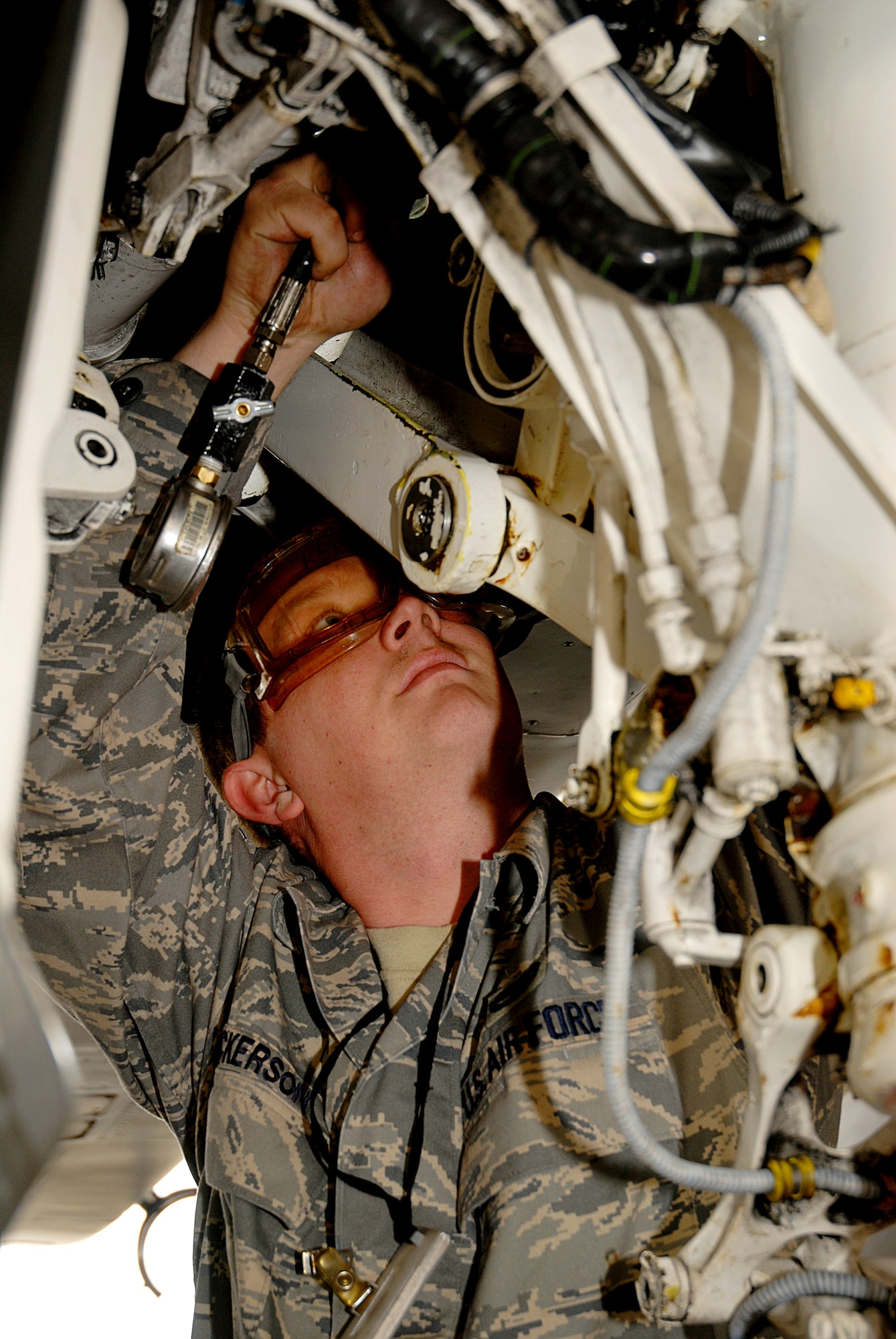 Senior Airman Brandon Hickerson, 18th Aircraft Maintenance Squadron, services the right strut on an F-15C, during the 2008 Pacific Air Forces Operational Readiness Inspection at Kadena Air Base, Japan, March 10, 2008. PACAF is conducting the inspection from March 9 to 15 to validate the mission readiness of the 18th Wing. (U.S. Air Force photo/Staff Sgt. Chrissy FitzGerald)